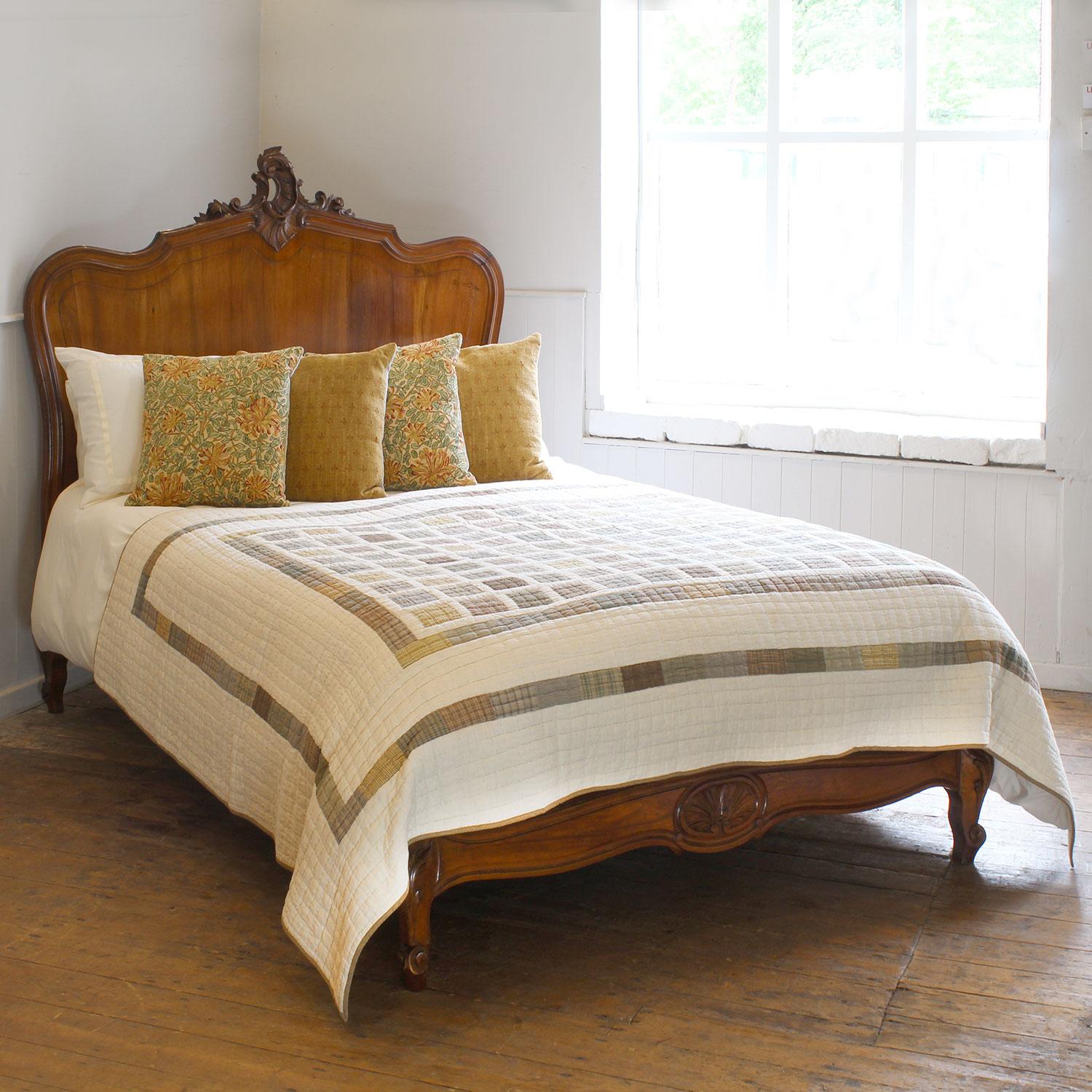 A Louis XV style bed in walnut with a low footboard.

This bed accepts a standard double, 4ft 6in (54 in), base and mattress set.

The price is for the bed frame and a firm bed base. 

The mattress, sprung bed base, bedding and linen are extra and