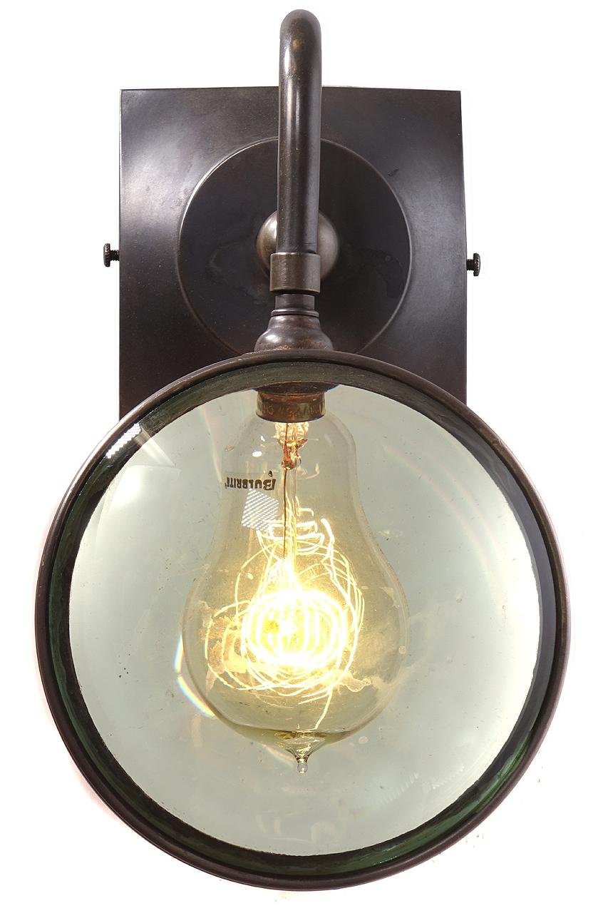 This sconce is totally unique there is nothing out there likes it. It takes a single candelabra bulb that looks larger in the thick magnifying glasses. With an antique style filament bulb the look is mesmerizing. Each glass lens is almost 2 inches
