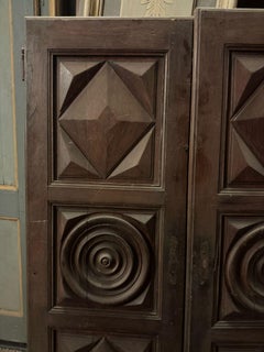 double oak doors, with carved panels with geometric decorations, Italy