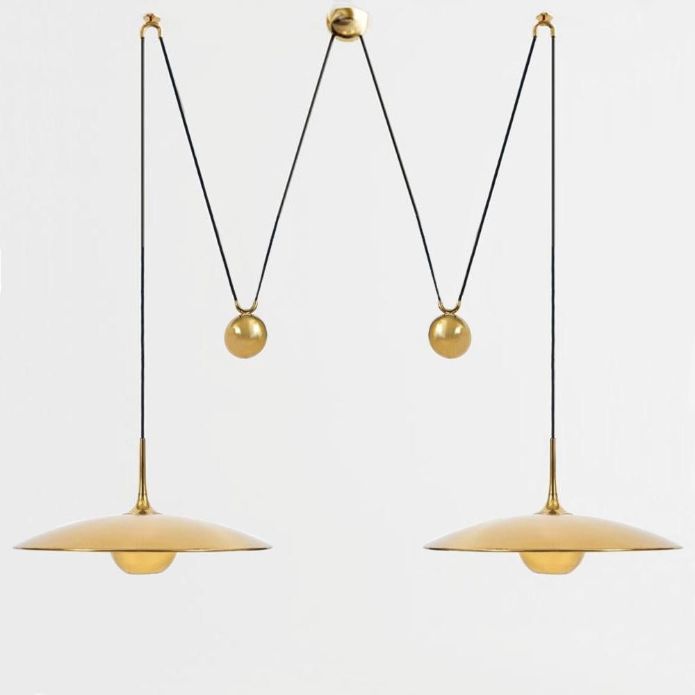 Fantastic Florian Schulz double counter balance pendants by Florian Schulz. Design period 1970-1979 production period 2022
Two unlackered brass pendants suspended with their own brass ball counter balance. One canopy supports both pendants. Each