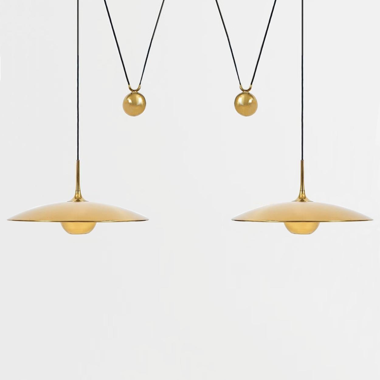 Fantastic Florian Schulz double counter balance pendants by Florian Schulz. Design period 1970-1979 production period 2000-2009

Two polished brass pendants suspended with their own brass ball counter balance. One canopy supports both pendants.