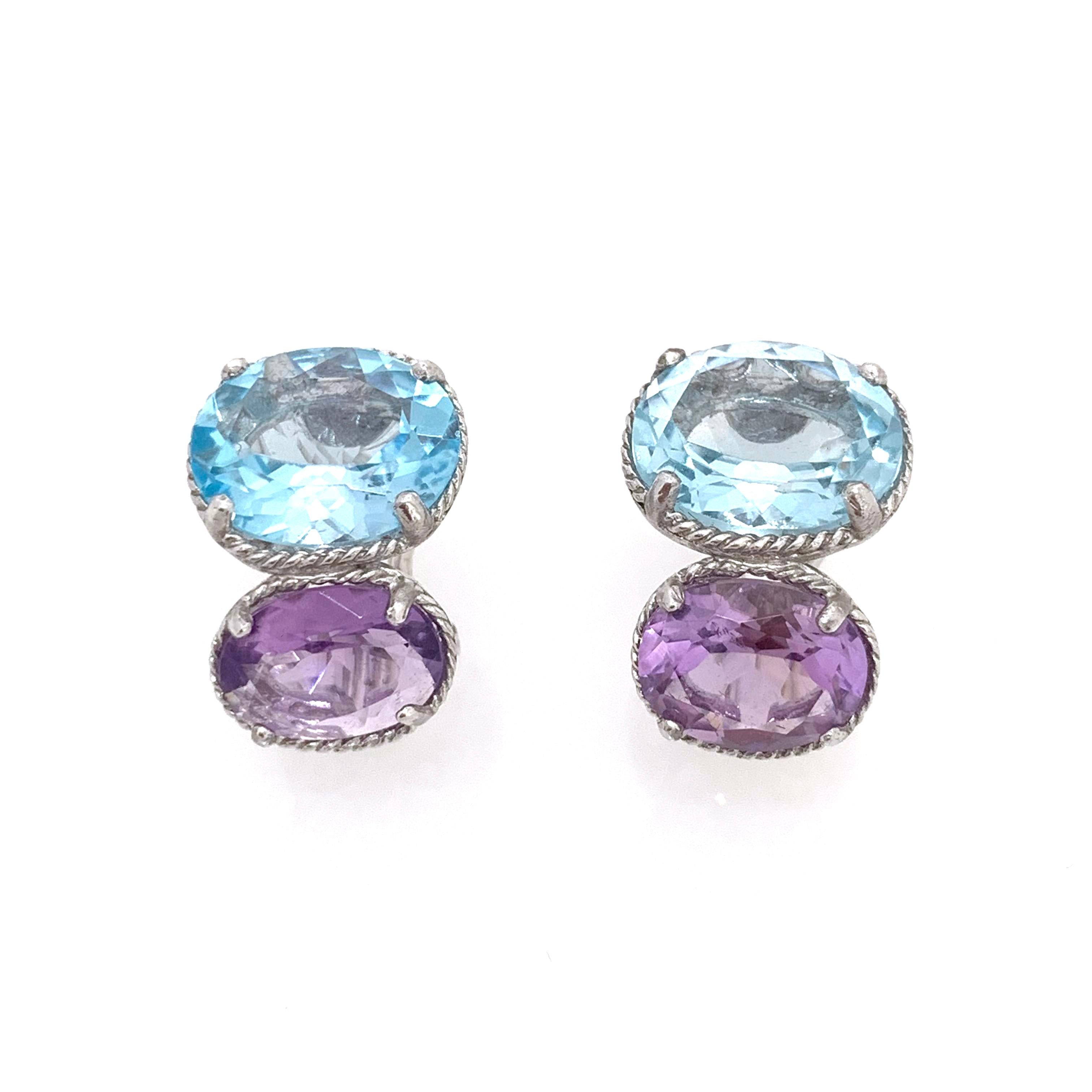 Stunning All-time Classic Bijoux Num Double Oval Blue Topaz and Amethyst Earrings. 

The earrings feature 4 beautiful AAA quality oval blue topaz and amethyst, handset in platinum plated sterling silver.  Straight post back with omega clip backing.