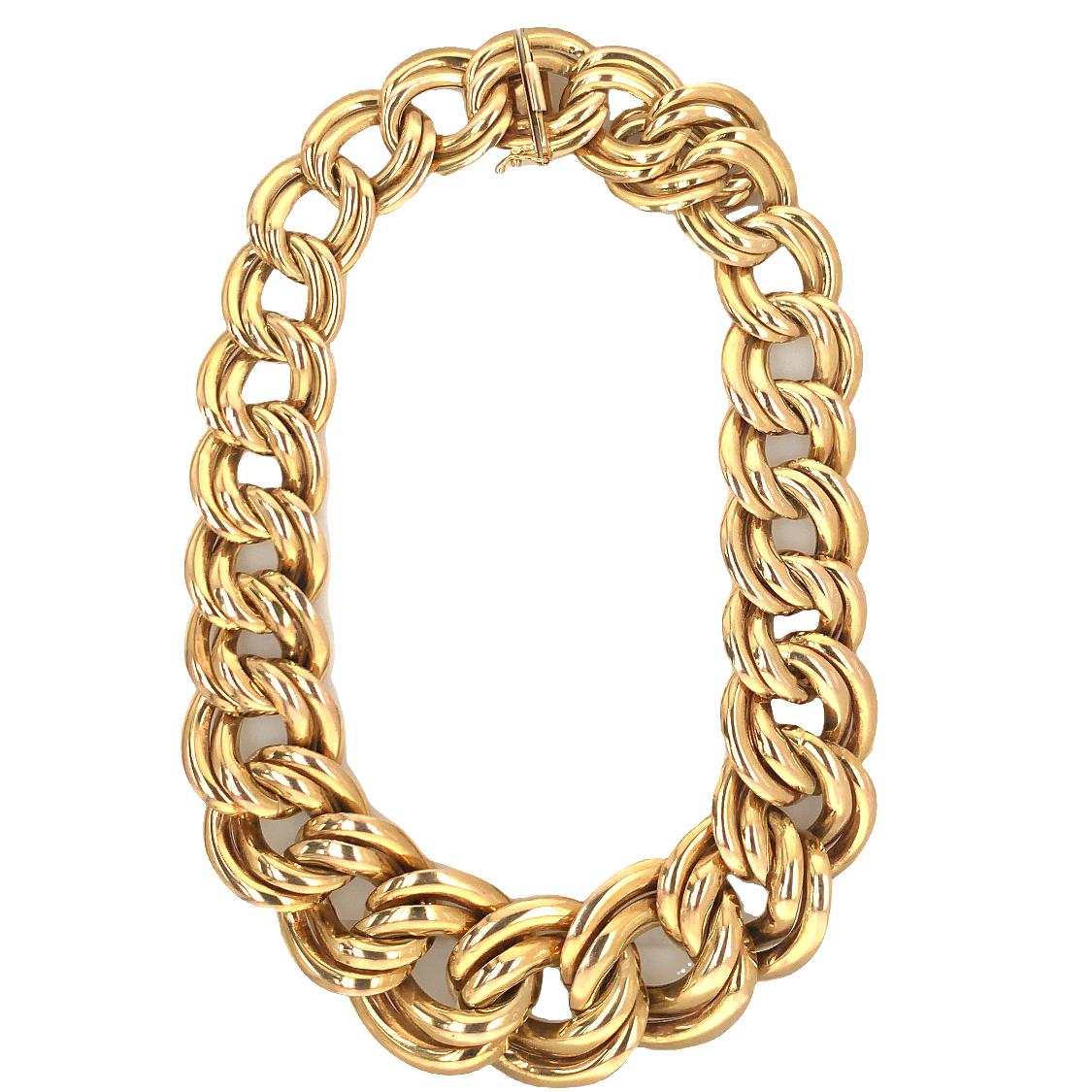 One oval double link 14K yellow gold necklace with a high polish finish throughout. The necklace measures 32 mm. wide at the center and tapers to 20 mm. wide at the clasp. Circa 1970s.

Chunky, grand, flash.

Metal: 14k yellow gold
Circa: