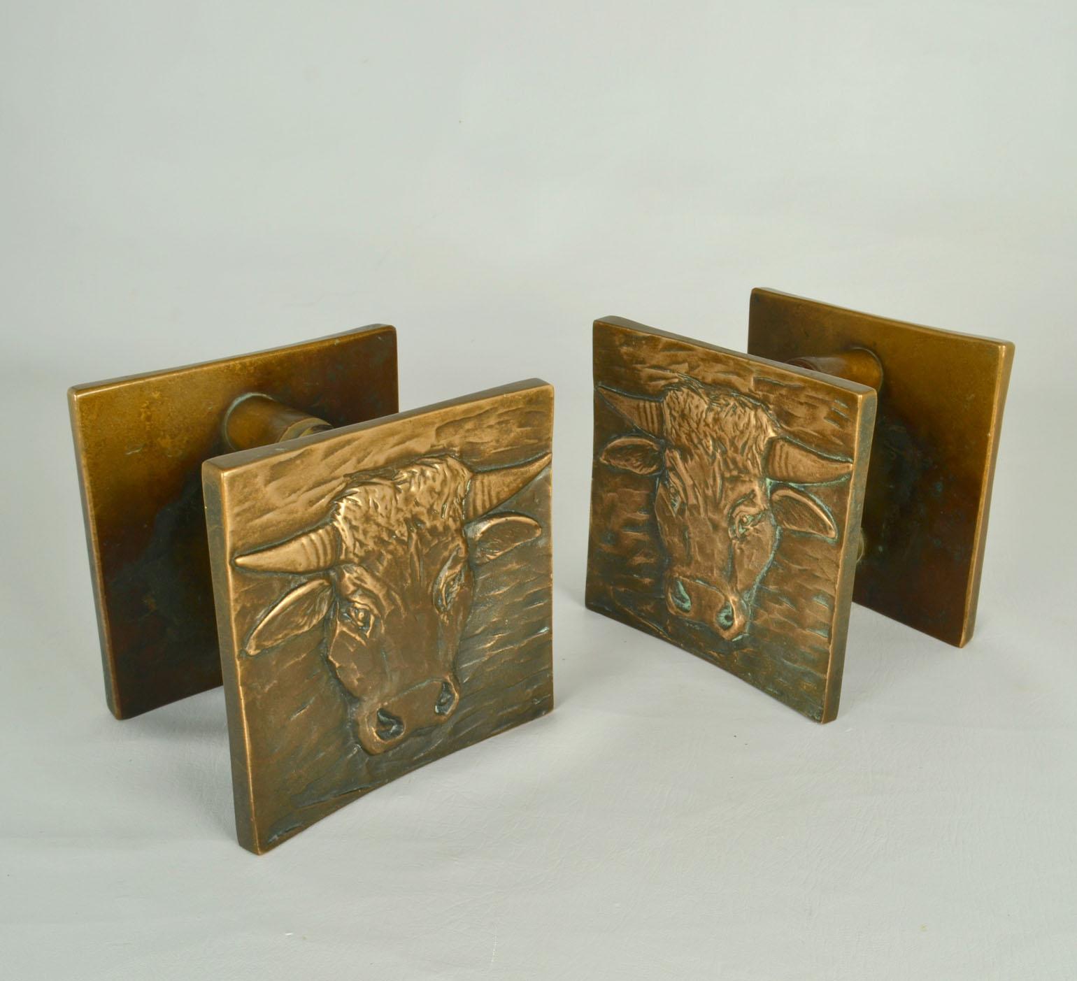 Set of two large square double bronze door handles expressing bulls, European 1970's. Their reliefs have the original patina of age. 
These identical handles can be applied inside or outside on a pair of double doors next to each other, on a single