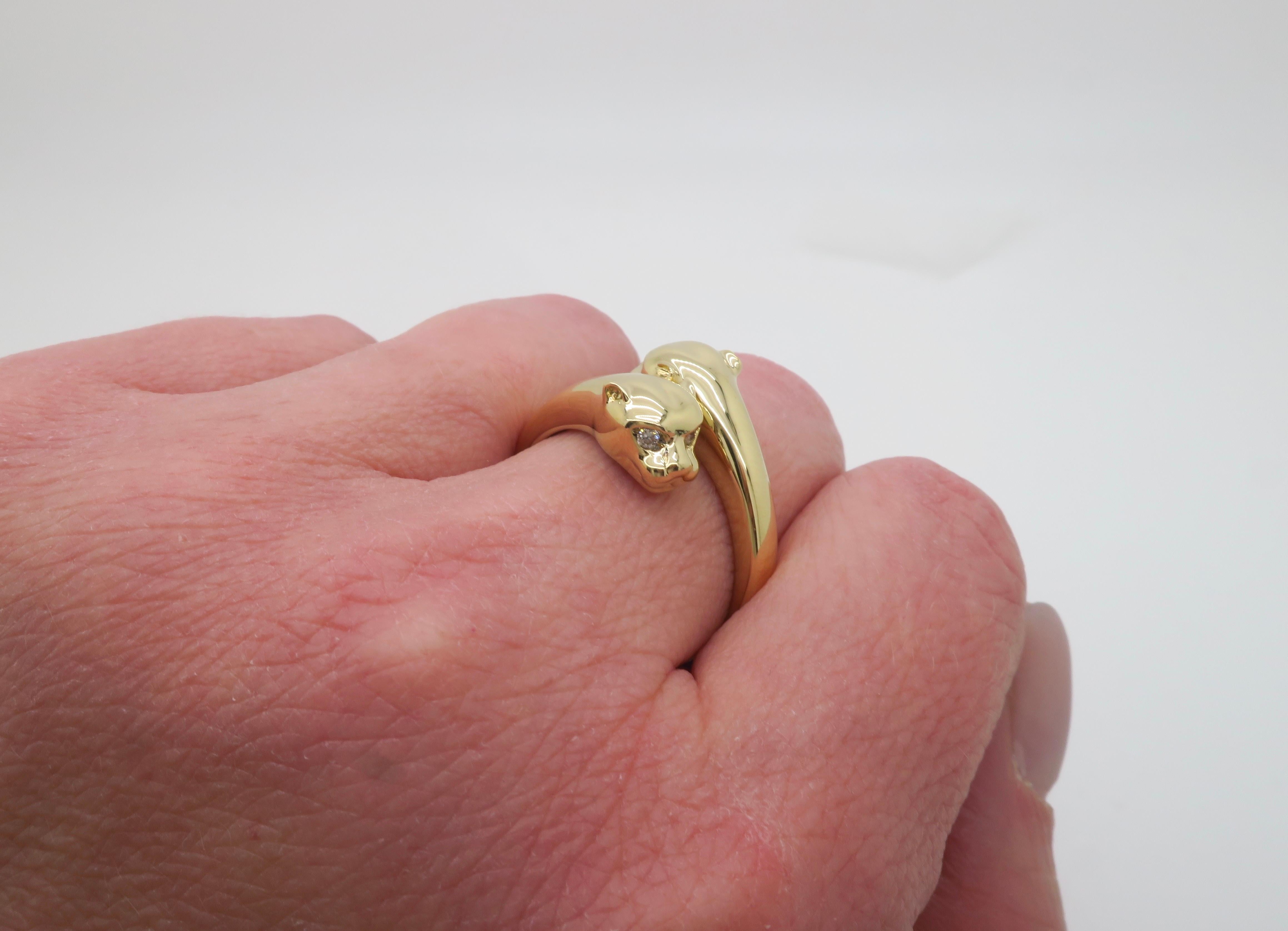 Double Panther ring crafted in 14k yellow gold with diamond eyes. 

Diamond Carat Weight: .10CTW
Diamond Cut: Round Brilliant cut 
Color: E-G
Clarity: VS1-SI1
Metal: 14k Yellow gold 
Stamped: 