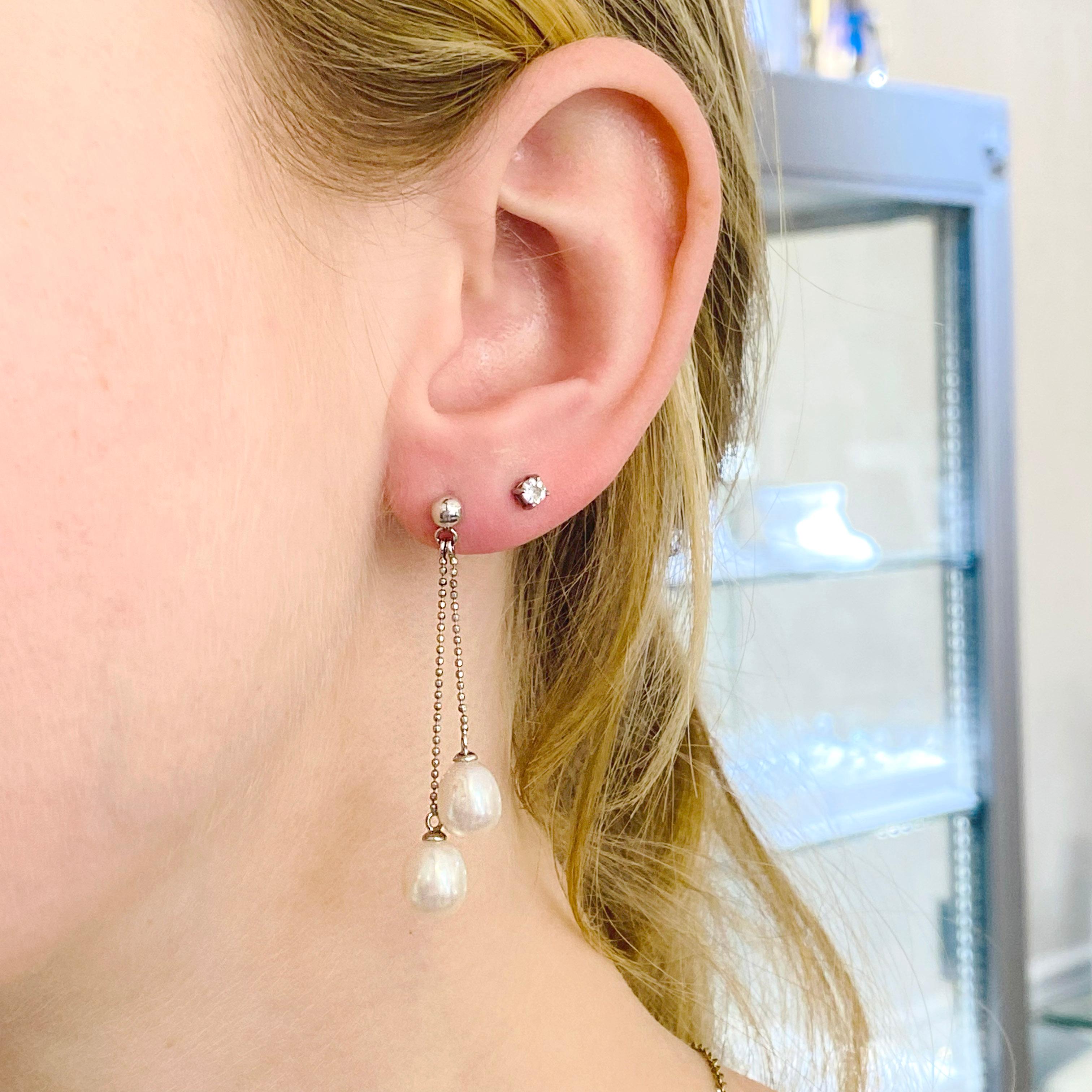 These luscious genuine cultured pearl earrings have a beautiful diamond cut beaded chain that dangles from a ball stud. These earring embellishments are perfect for a dressy or casual occasion. The details for these gorgeous earrings are listed