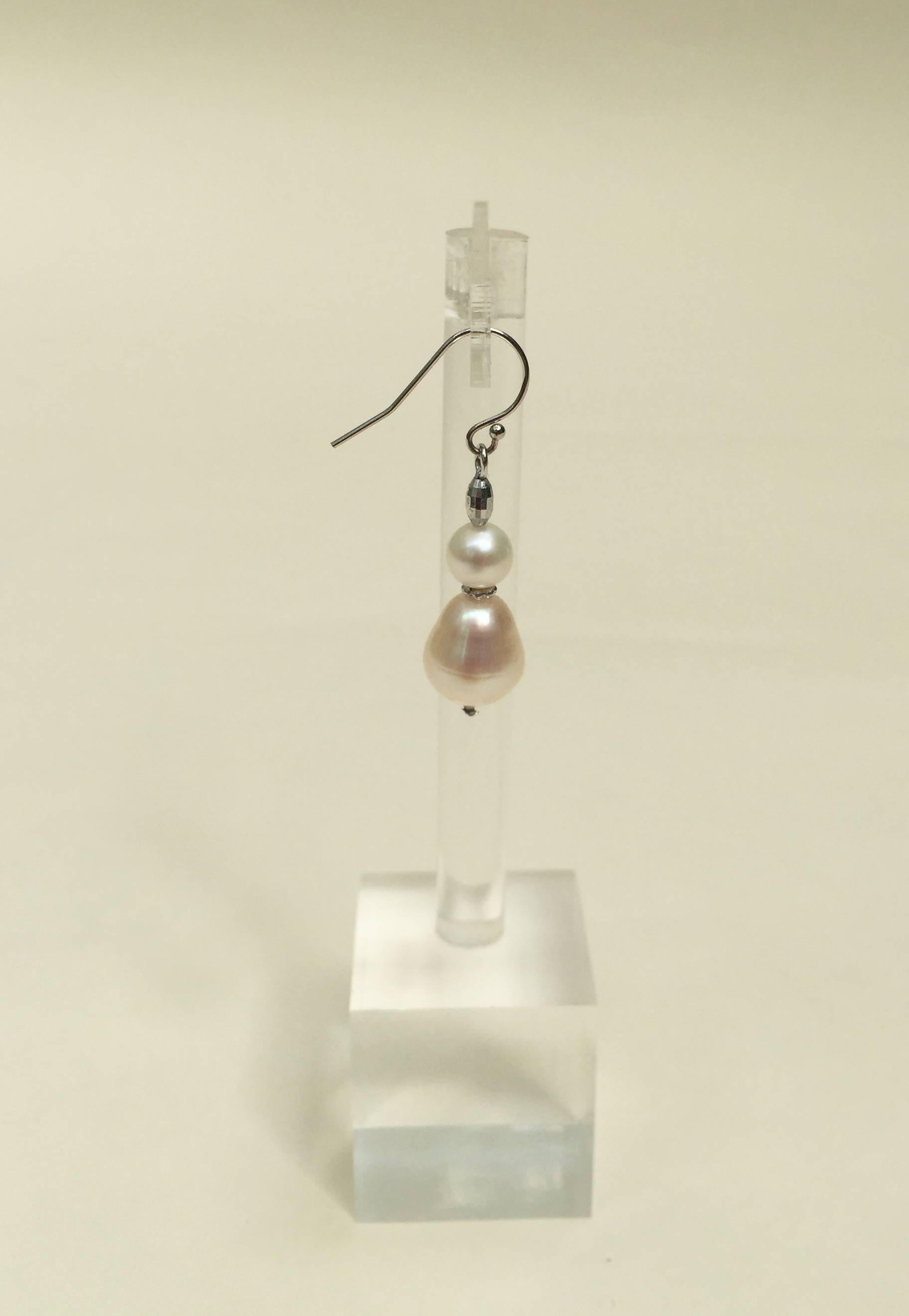 These double pearl earrings are classic and elegant, highlighted with a platinum plated silver beads separating the pearls. The 14k white gold hook completes these timeless earrings. 
As part of a set, with the graduated pearl drape necklace these