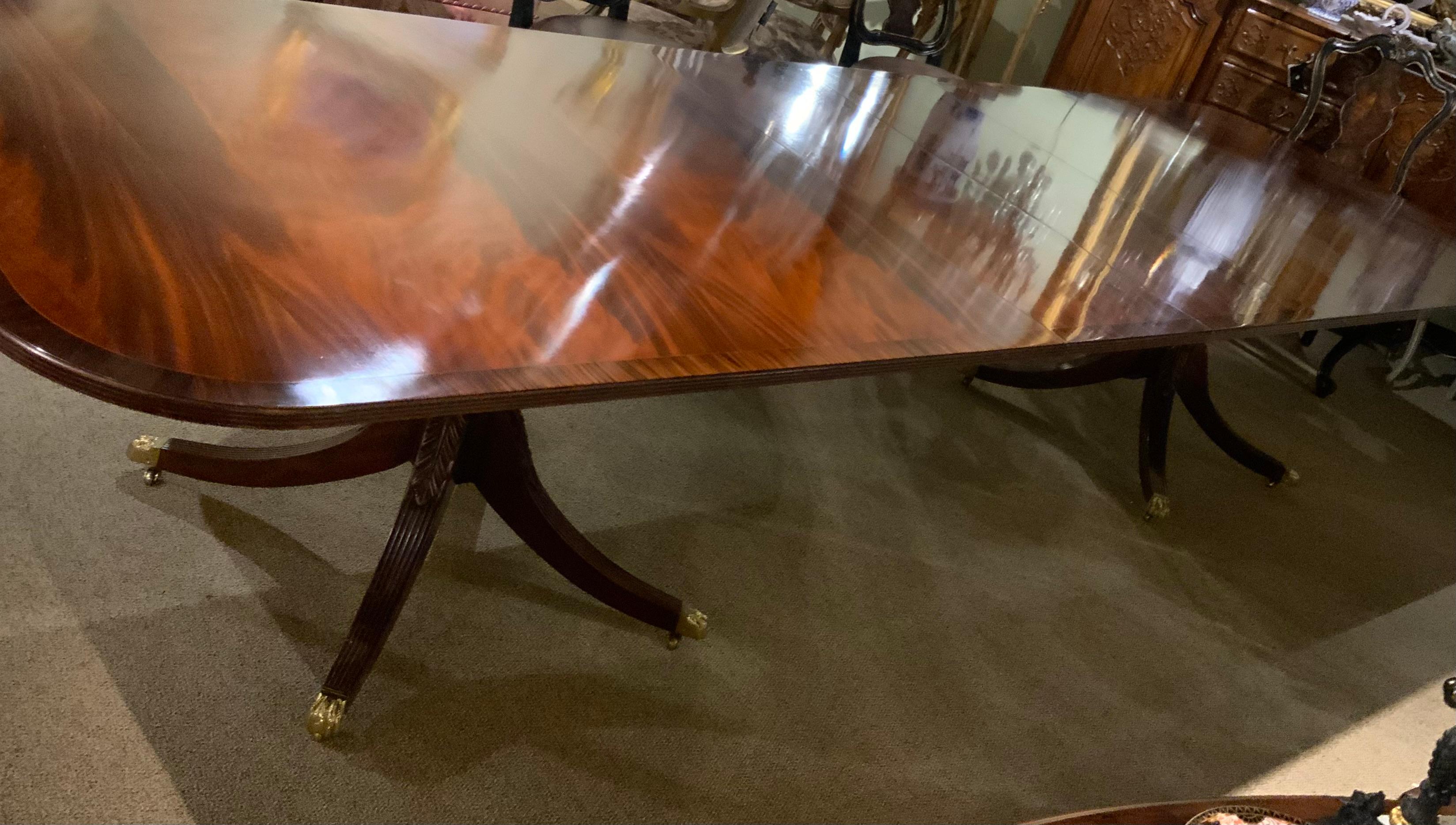 This flame mahogany table is made of the finest wood.
It was custom made by a New York cabinet maker by
Smith and Watson. Each pedestal is well carved with 
Four legs that spay outward and that have feet with
Brass toes and castors. The edge of the