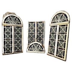 Double orangery door and its pair of colored glass bay windows