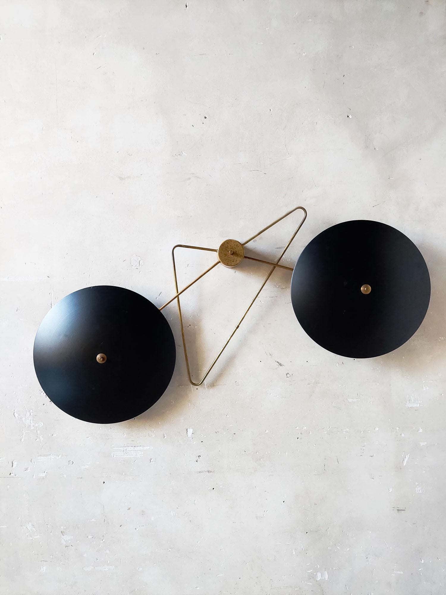 Double reflector wallight by Bruno Gatta for Stillnovo. A large brass frame with two large black powder-coated metal saucer lamps, round shell reflectors. Each has 3 lightpoints.

total width 150 cm, diameter saucers 53 cm each