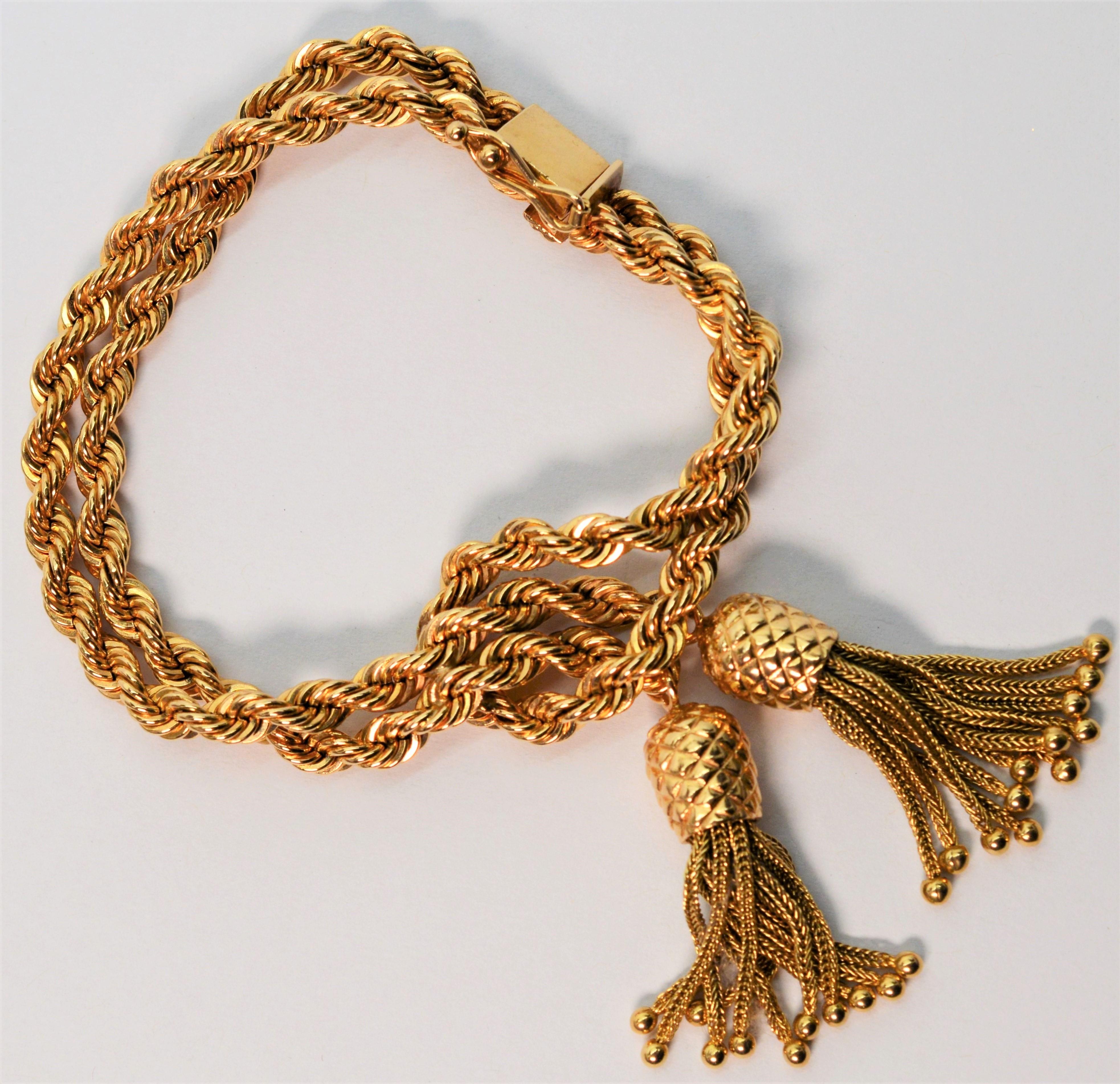 Love this fabulous double rope gold chain bracelet with unique flirty pineapple inspired tassels. Two 4.5mm rope style chains in fourteen karat 14K yellow gold, intentionally relaxed, casually wrap the wrist creating interest and movement. Measuring