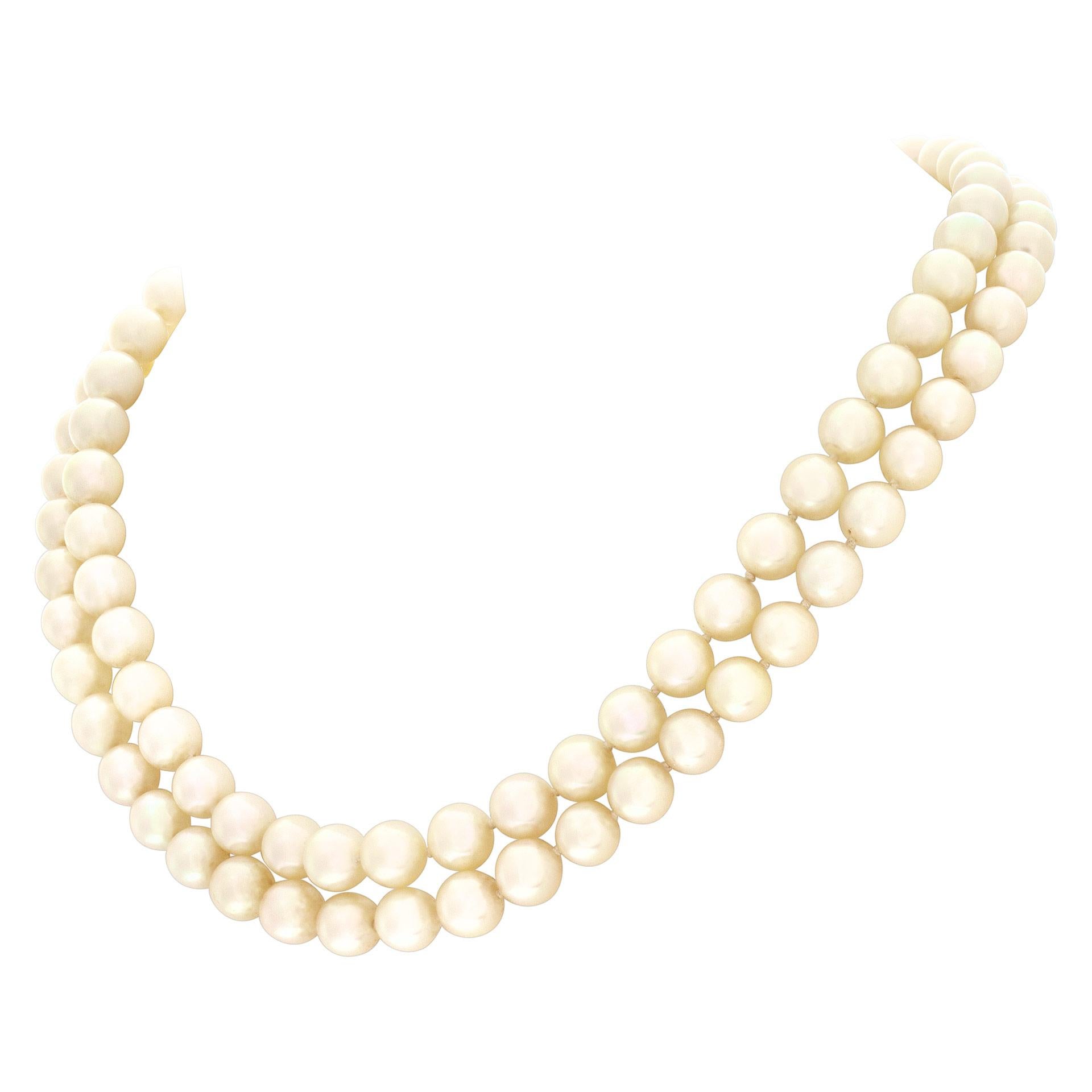Double row 7 x 7.5mm cultured pearl necklace with 14k white gold diamond, sapphire and pearl clasp. Length 16 inches.