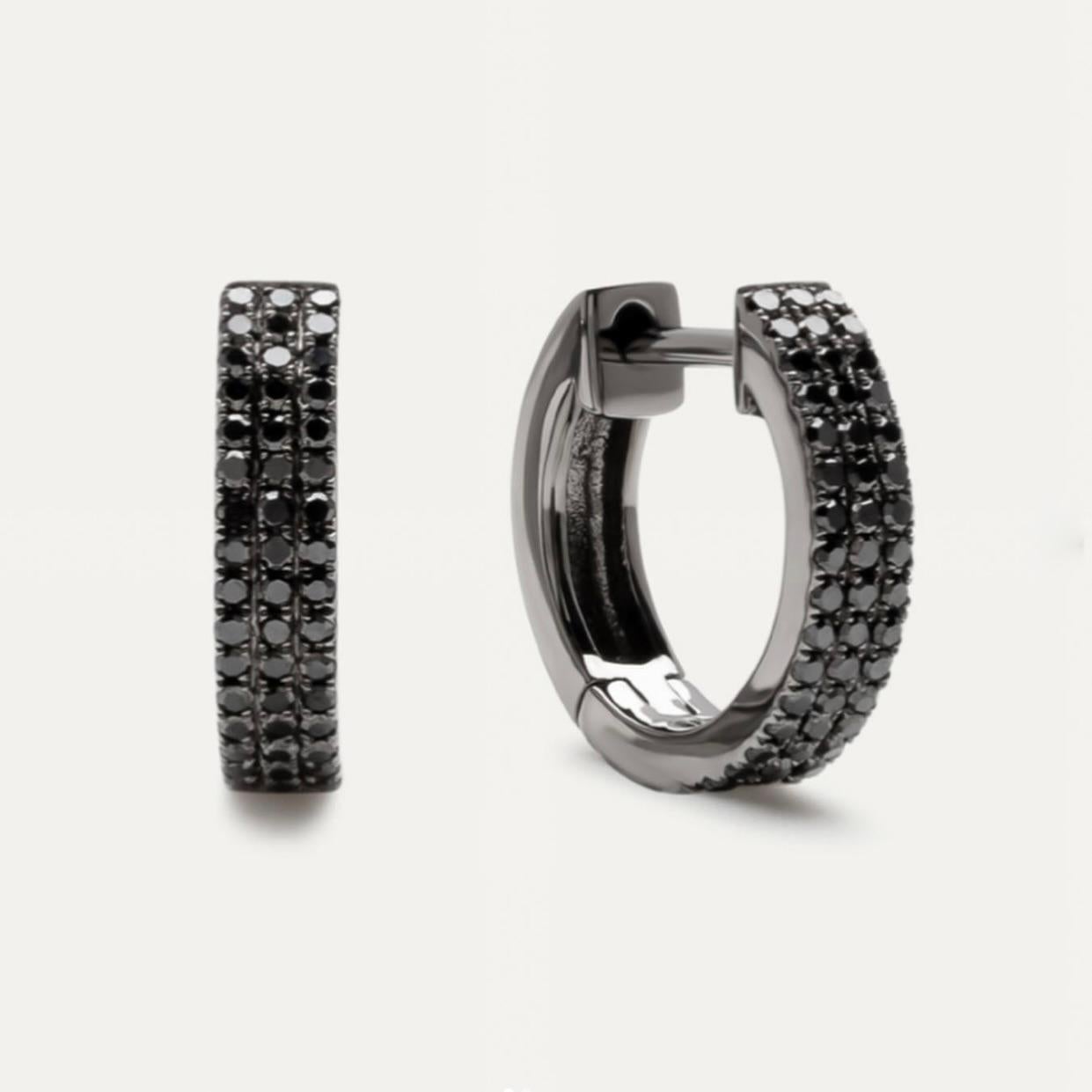 Double Row Black Diamond Huggies are a mesmerizing and edgy variation of classic hoop earrings. These captivating hoops feature two rows of brilliant black diamonds meticulously set in a closely spaced arrangement, creating a stunning contrast