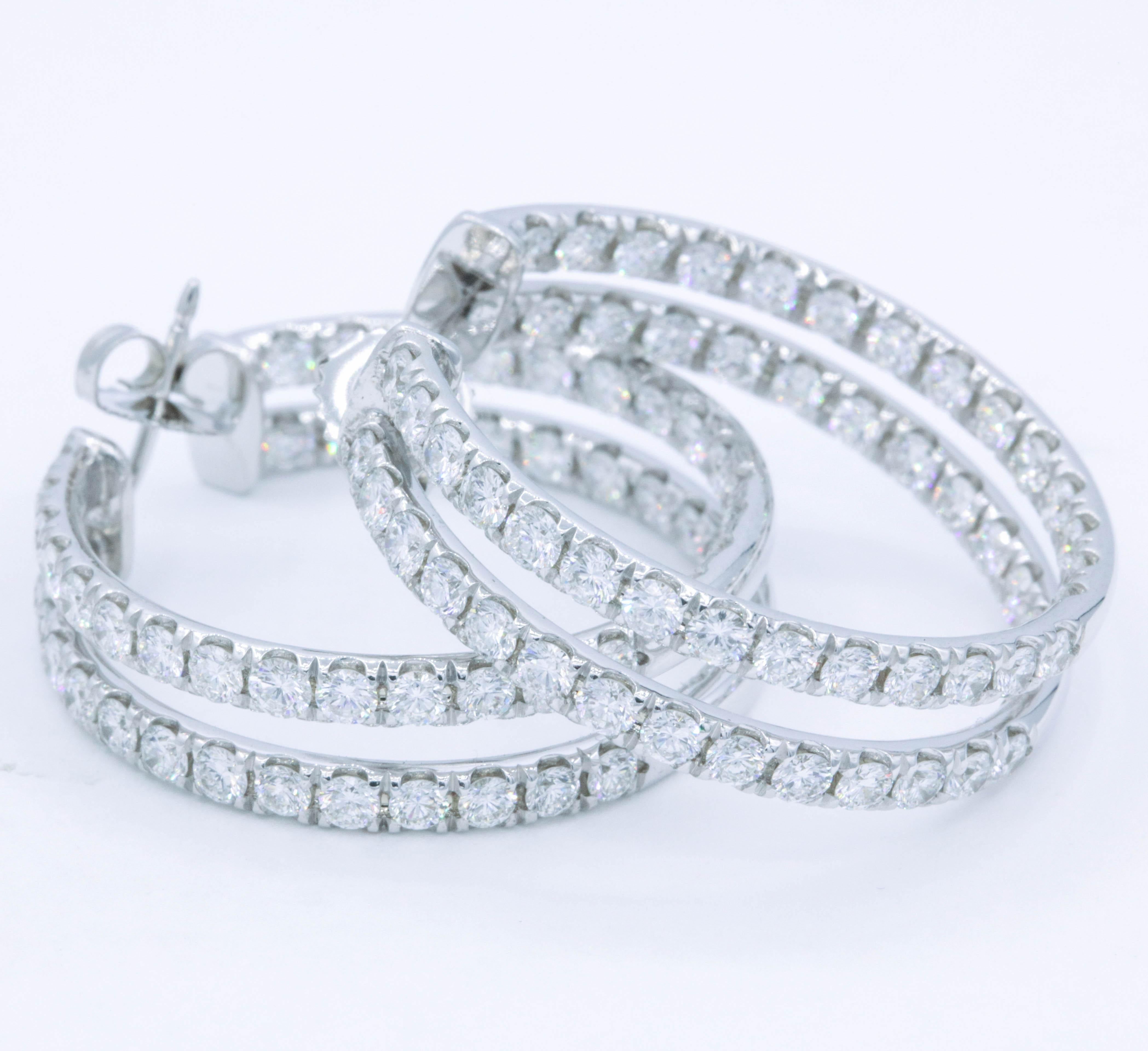 Double row hoop earrings containing 112 round brilliants, weighing 5.60 carats, in 14k white gold. 
Color: G-H
Clarity: SI