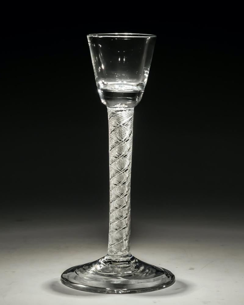 A double series air twist cordial glass.

England, circa 1750.

Measures: height: 16.5 cm (6 1/2