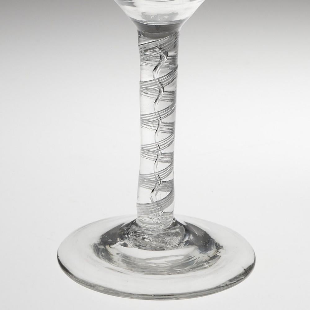 Heading : Air twist stem Georgian wine glass
Period : George II - c1750
Origin : England
Colour : Clear
Bowl : Round funnel
Stem : A five-ply spiral band outwith a spiral core
Foot : Conical
Pontil : Snapped
Glass Type : :Lead
Size :  14.7cm height,