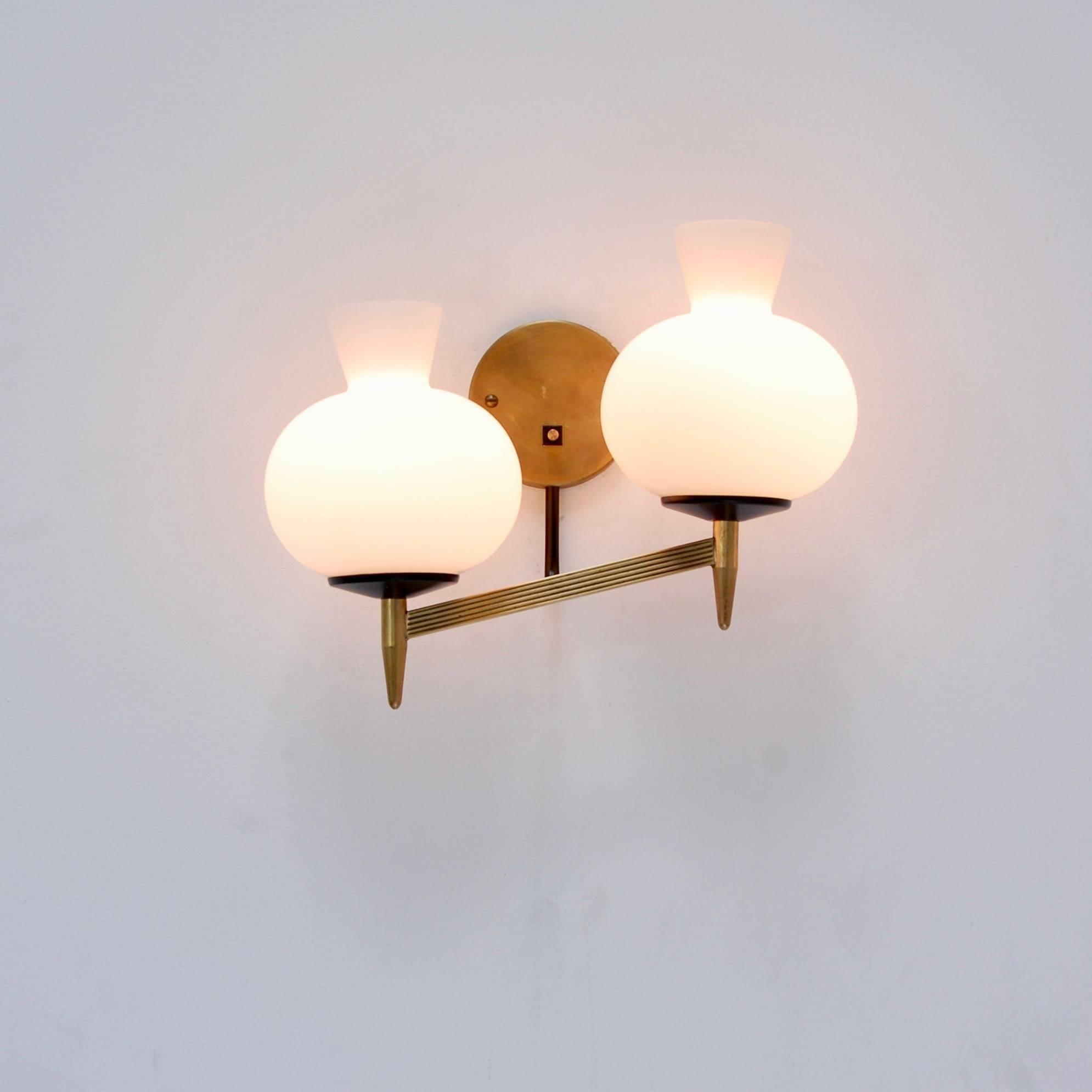 Four double shade sconces from 1950s Italy in glass, brass and steel. Partially restored. Currently wired for use in the US. Priced individually.
Measurements:
Height 10”
Depth 7”
Width 12”.
  