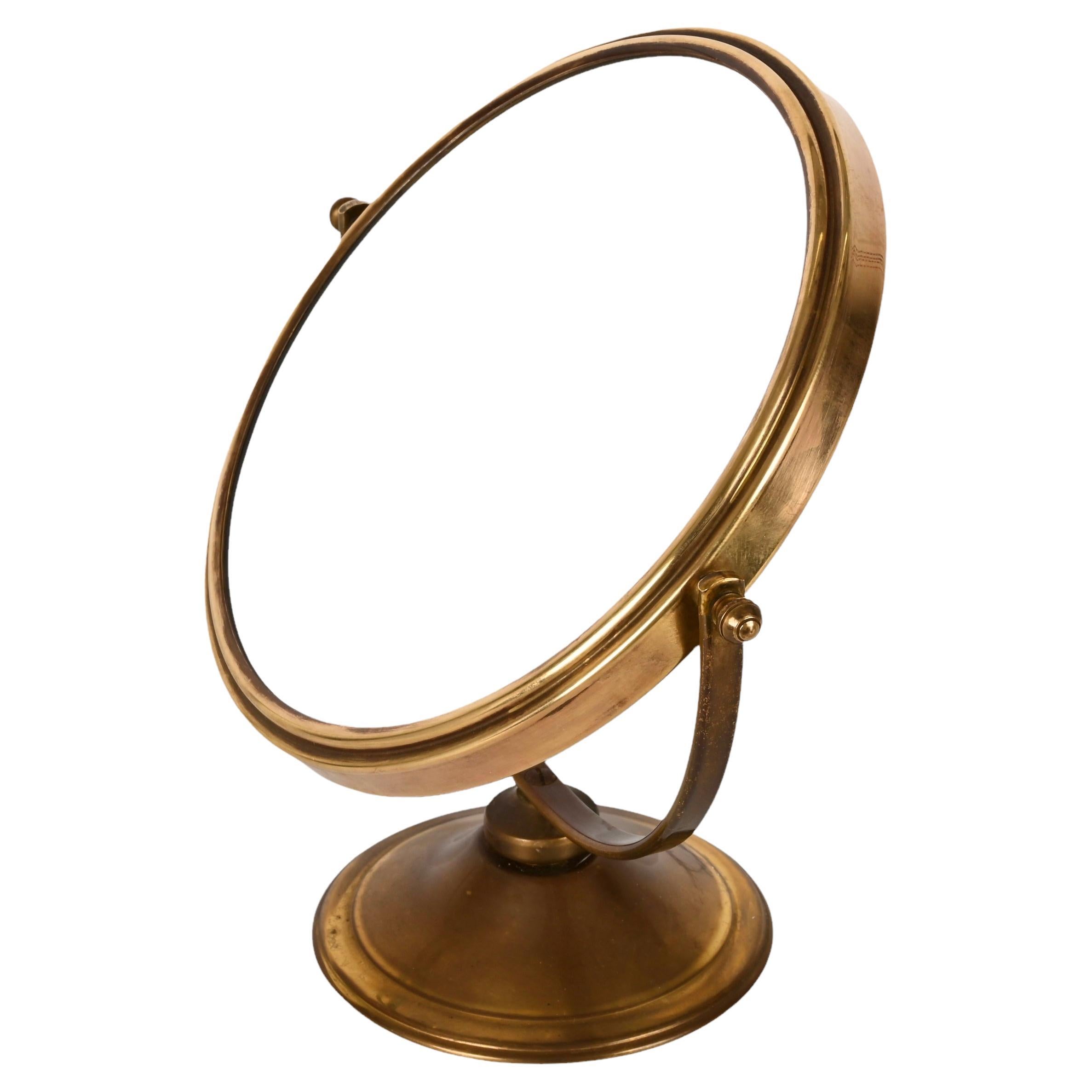 Magnificent midcentury double-sided adjustable and magnified brass vanity table mirror. This fantastic piece was designed in Italy during the 1960s.

This piece is mind-blowing because of its brass structure, plus it is fully adjustable and the