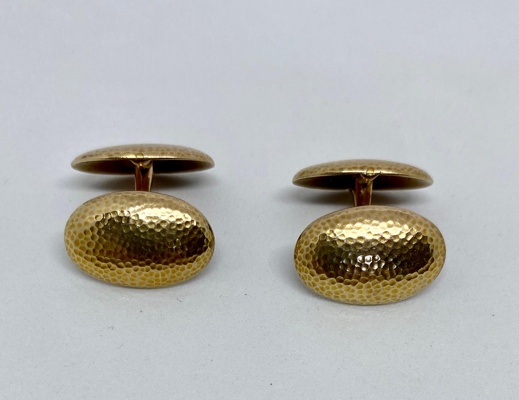 Beautiful hammered gold cufflinks in solid yellow gold with hinged backs.

These cufflinks bear a Continental maker's mark and 585 indicating solid, 14K gold. The four oval faces measure 18.5 by 11.8mm. Together the pair weighs a substantial 13.61