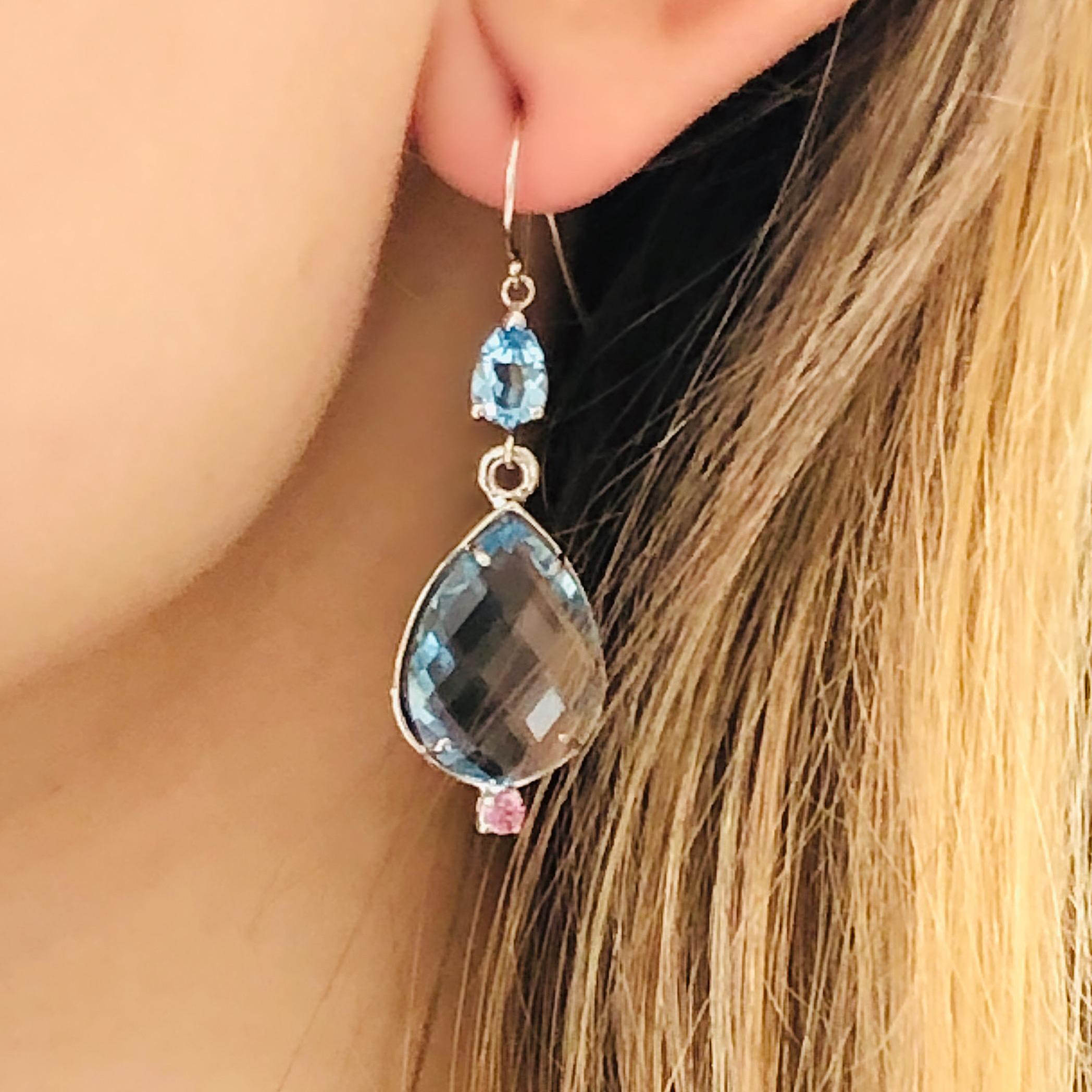 Fourteen karats white gold hoop earrings
Two double-sided Briolette pear-shaped blue Topaz weighing  7.00 carats
Two pear shape blue topaz weighing 2.00
Two pink sapphires weighing 0.50
New earrings
Handmade in the USA
