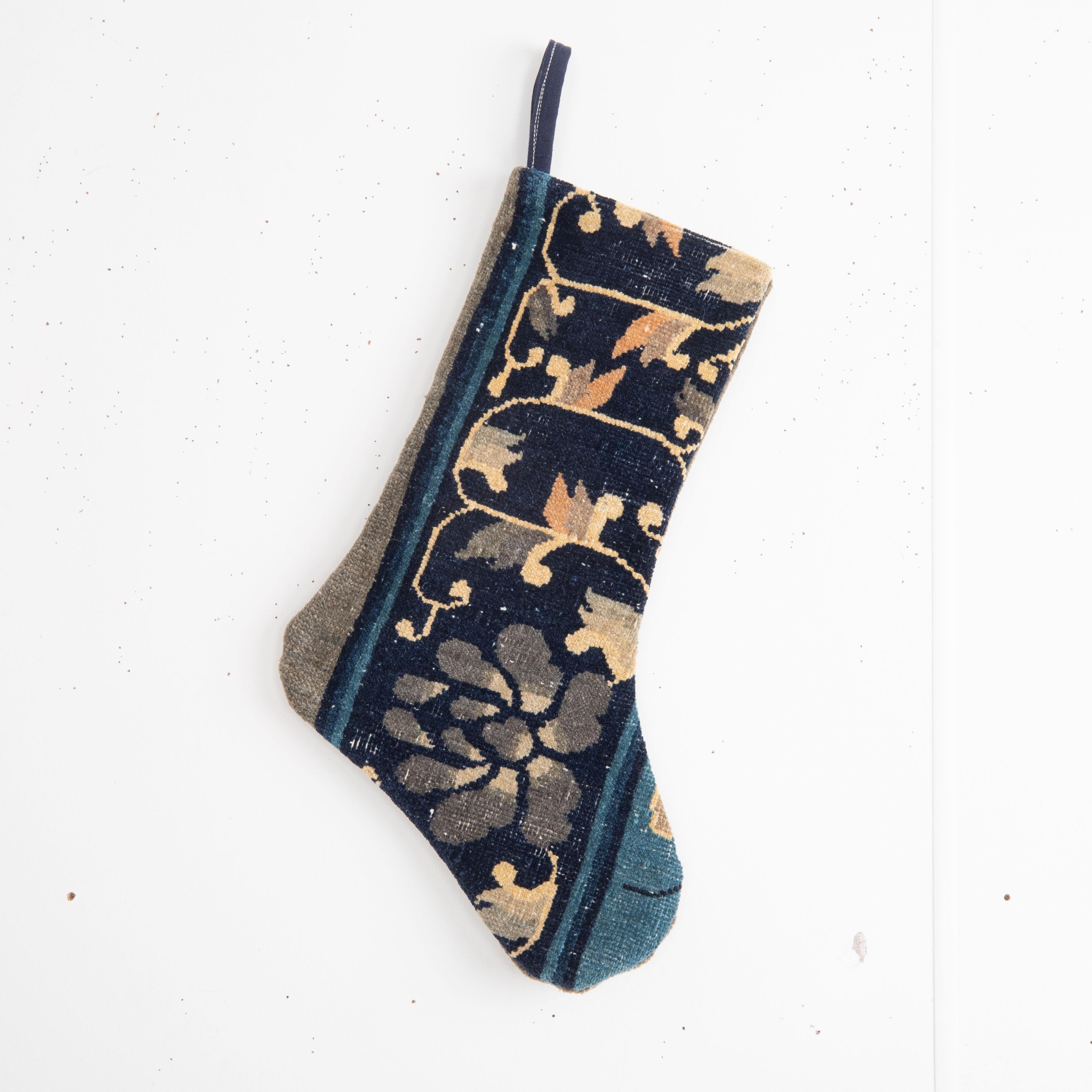 This Christmas Stocking was made from a late 19th or Early 20th C. Chinese rug fragments.

Please note, this stocking was made from Chinese rug fragments.


