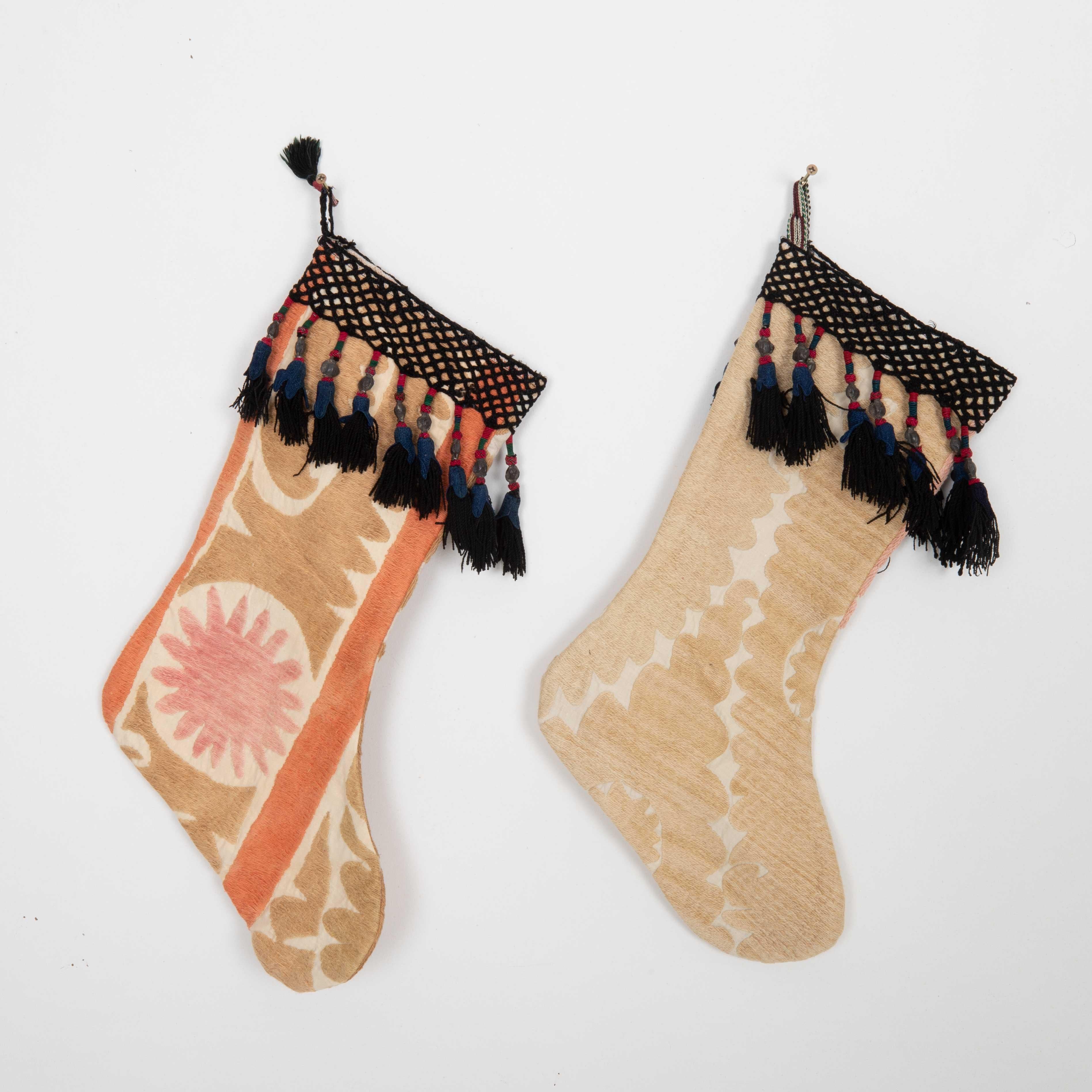These Christmas Stockings were made from mid 20th C. Uzbek Suzani Fragments.

Please note these were made from vintage suzani fragments.
