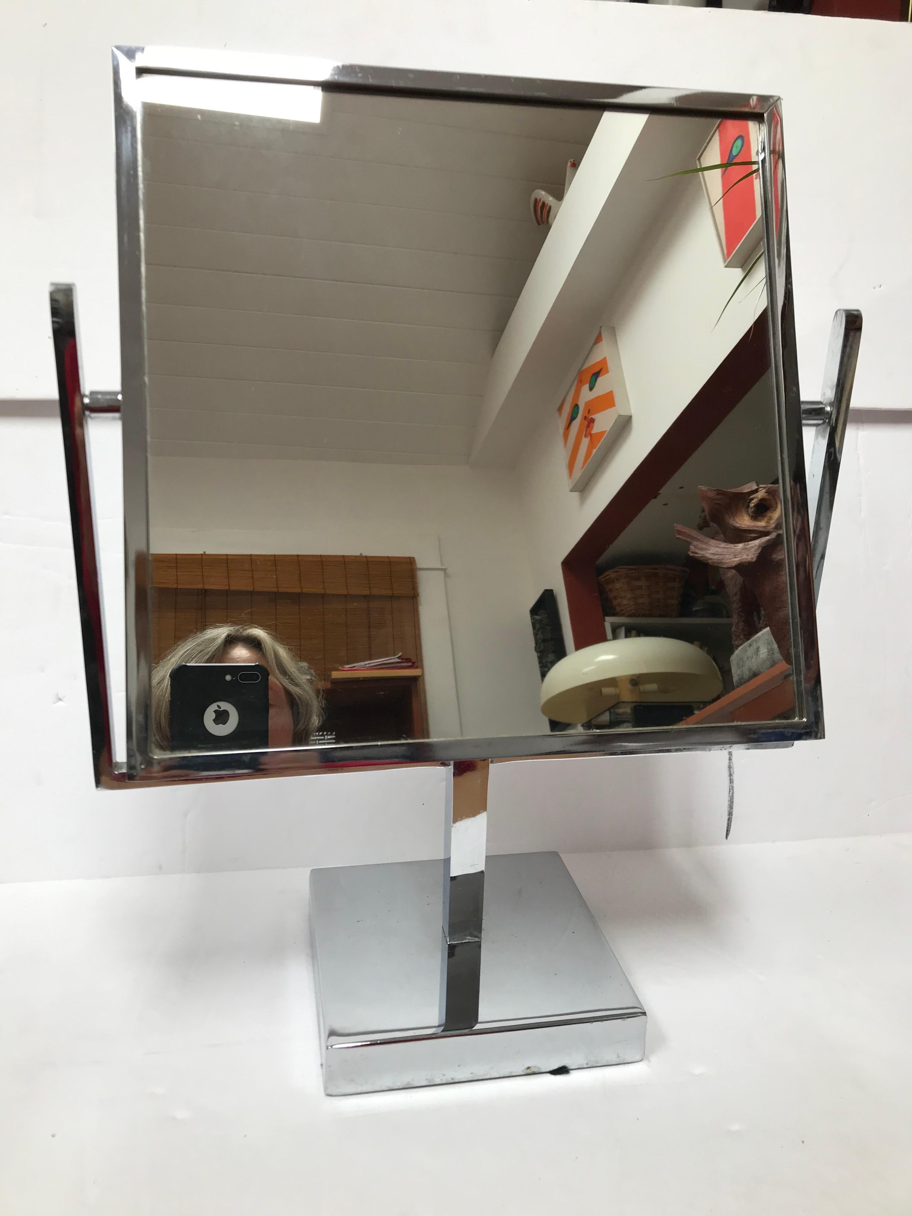 This Double Sided Chrome Vanity Mirror is attributed to Charles Hollis Jones. It has a chrome base and a double sided mirror, typical of the 1970s.

Charles Hollis Jones is an American artist and furniture designer who is recognized by the