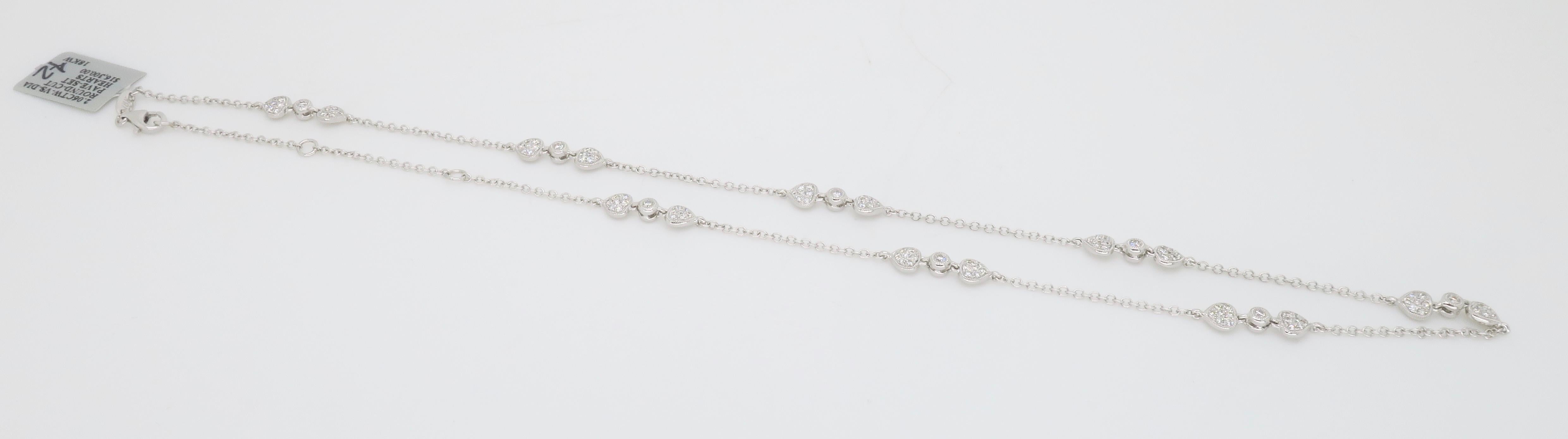 Versatile diamond station necklace featuring pavé set diamond on both sides of each station, crafted in 18K white gold.

Diamond Carat Weight: Approximately 2.06CTW
Diamond Cut: Round Brilliant Diamonds
Color: Average F-G
Clarity: VS-SI
Metal: 18K