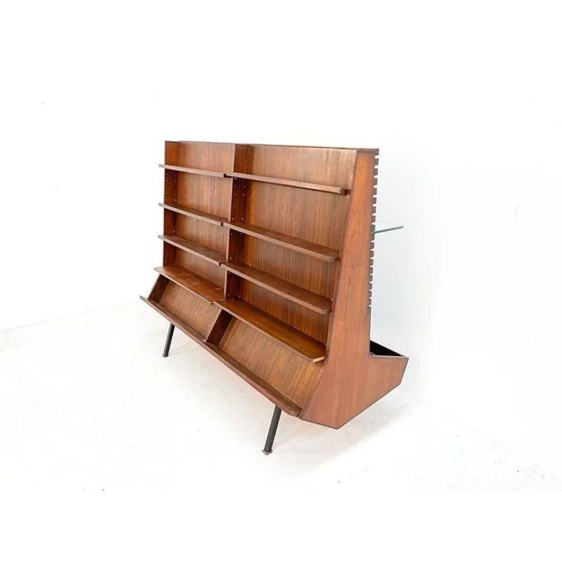 Double-sided display / cabinet in wood with glass

Two sided showcase, this showcase is probably made in The Netherlands. It shows two sides, one with glass and one with wooden shelves. You can adjust the glass and wooden shelves to the desired