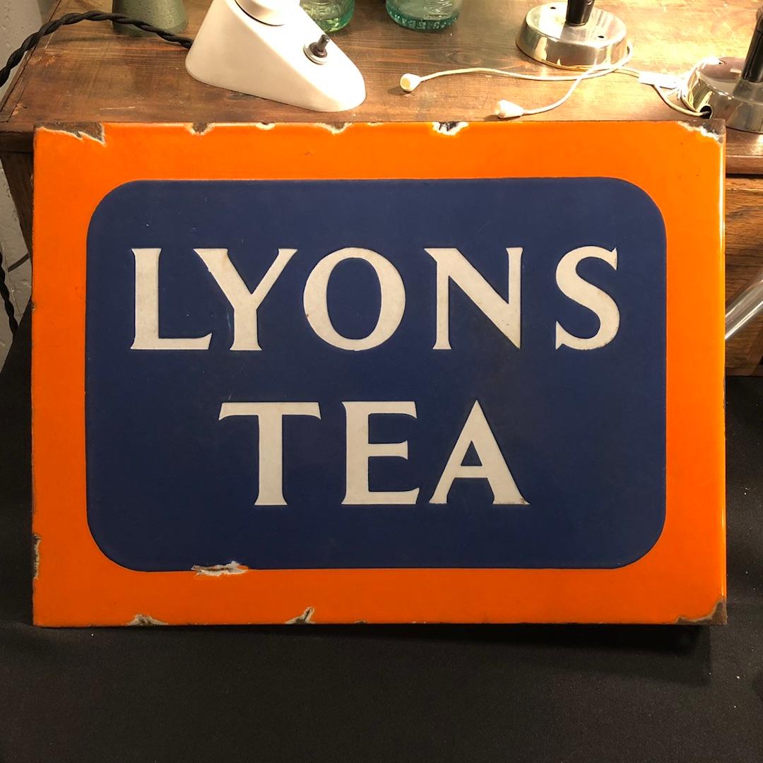 Pre WWII double sided enamel advertising sign for Lyons Tea. In a flag shape it is easily fixed on the wall to make an eye catching piece of decoration. In superb orange and blue colors, it is in rather good condition for its age with just a few