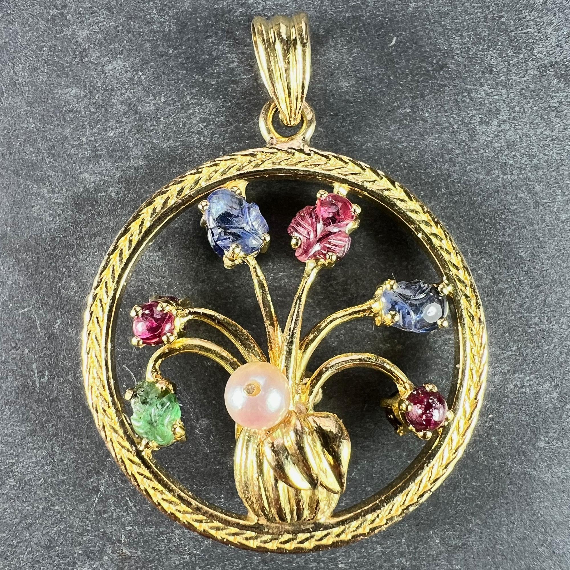 An 18 karat (18K) yellow gold double-sided pendant designed as a vase of flowers set to one side with a cultured pearl, a carved emerald, two ruby cabochons, two carved sapphires and a carved ruby. The other side is set with a turquoise cabochon,