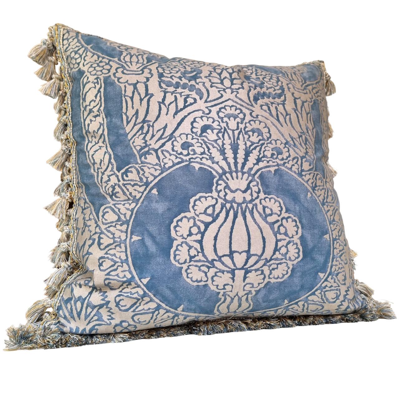 This amazing double-sided pillow is handmade using Fortuny fabric Nicolo pattern in blue and silvery gold color.
The pillow is embellished all along the four edges with multicolored luxurious tassel trim in blue and gold color.
The pillow cover is
