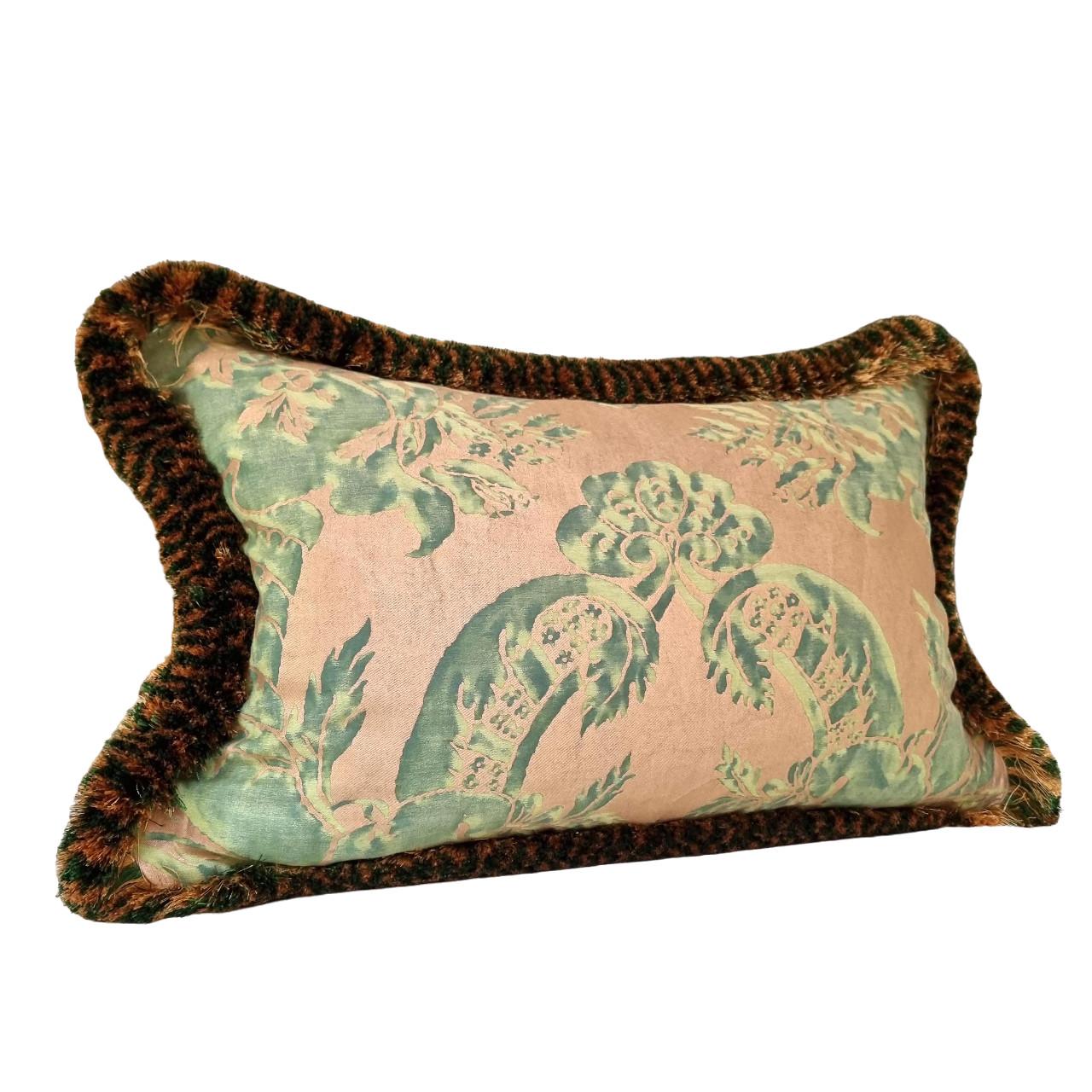 This amazing double-sided lumbar pillow is handmade using Fortuny fabric Olimpia pattern in green & silvery gold color.
The pillow is embellished all along the four edges with two-toned luxurious bullion fringe in green and gold color.
The pillow