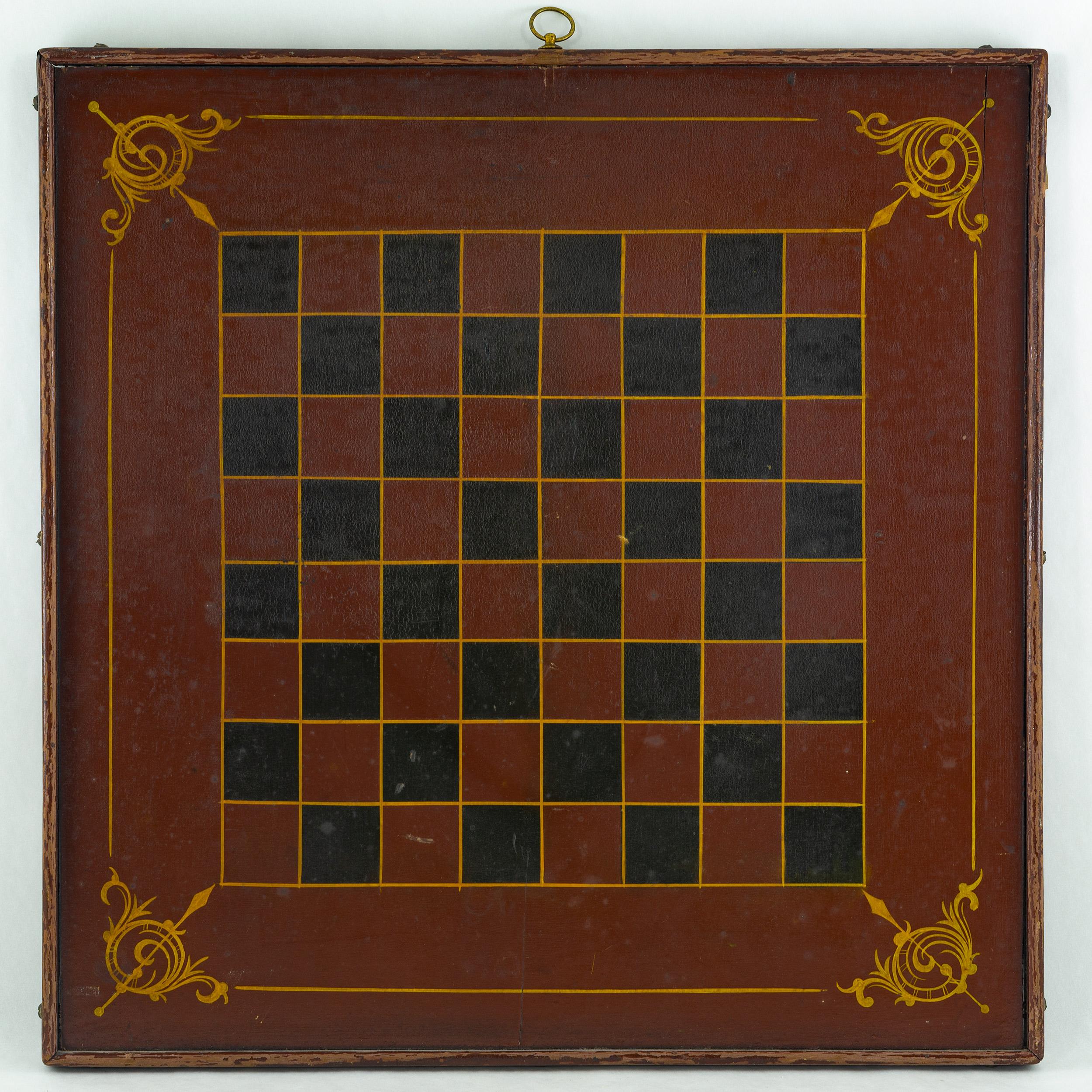 Polychrome double sided game board. The parcheesi board is painted with six colors, including a crimson red background and yellow dividing lines with red, green, blue, and black playing areas. The opposing side is a checkboard with a crimson red and