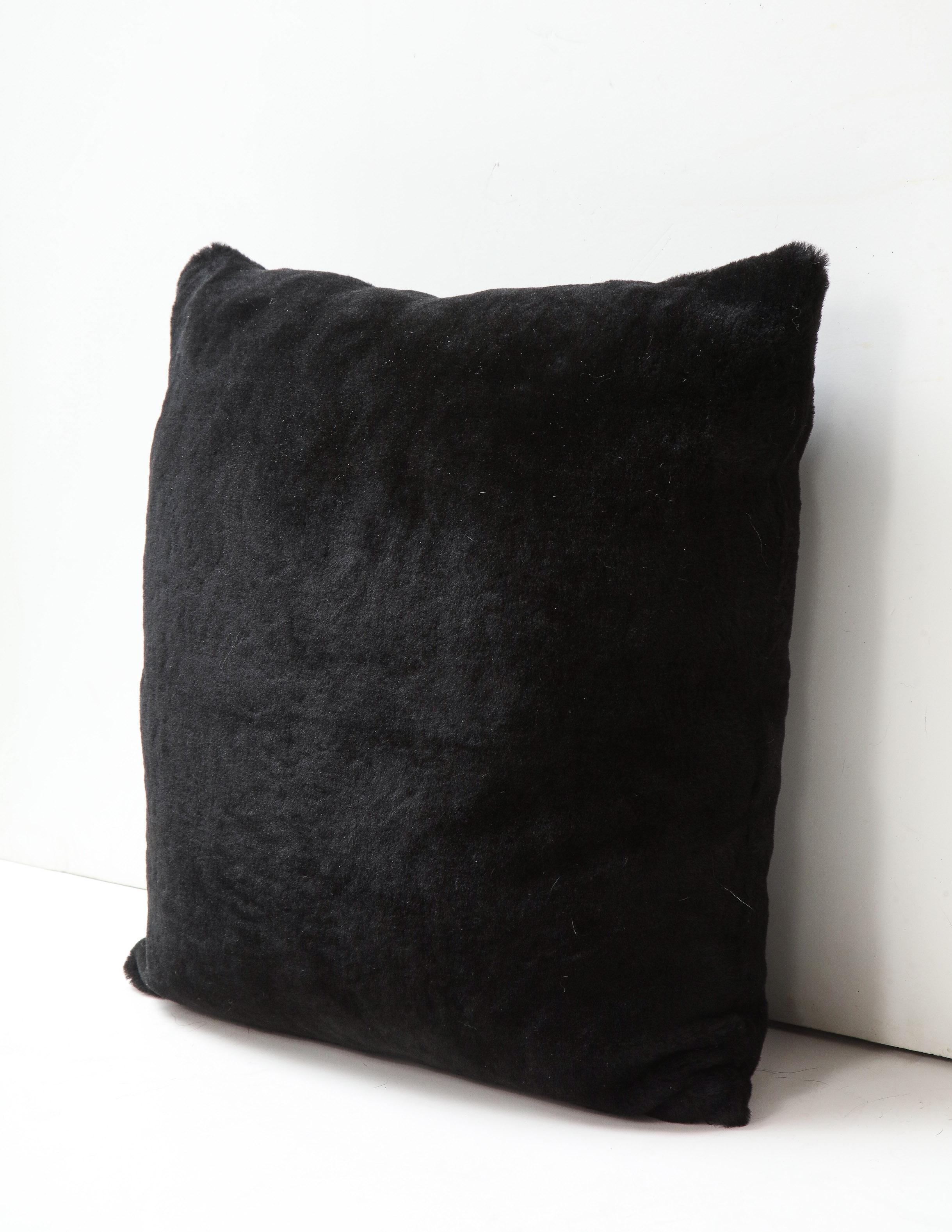 Beautiful custom double sided short hair Merino shearling pillow in black color. Very soft and luxurious in touch with modern appeal. It is made of genuine shearing with a zipper enclosure in a matching color, filled with down and feather, and 18