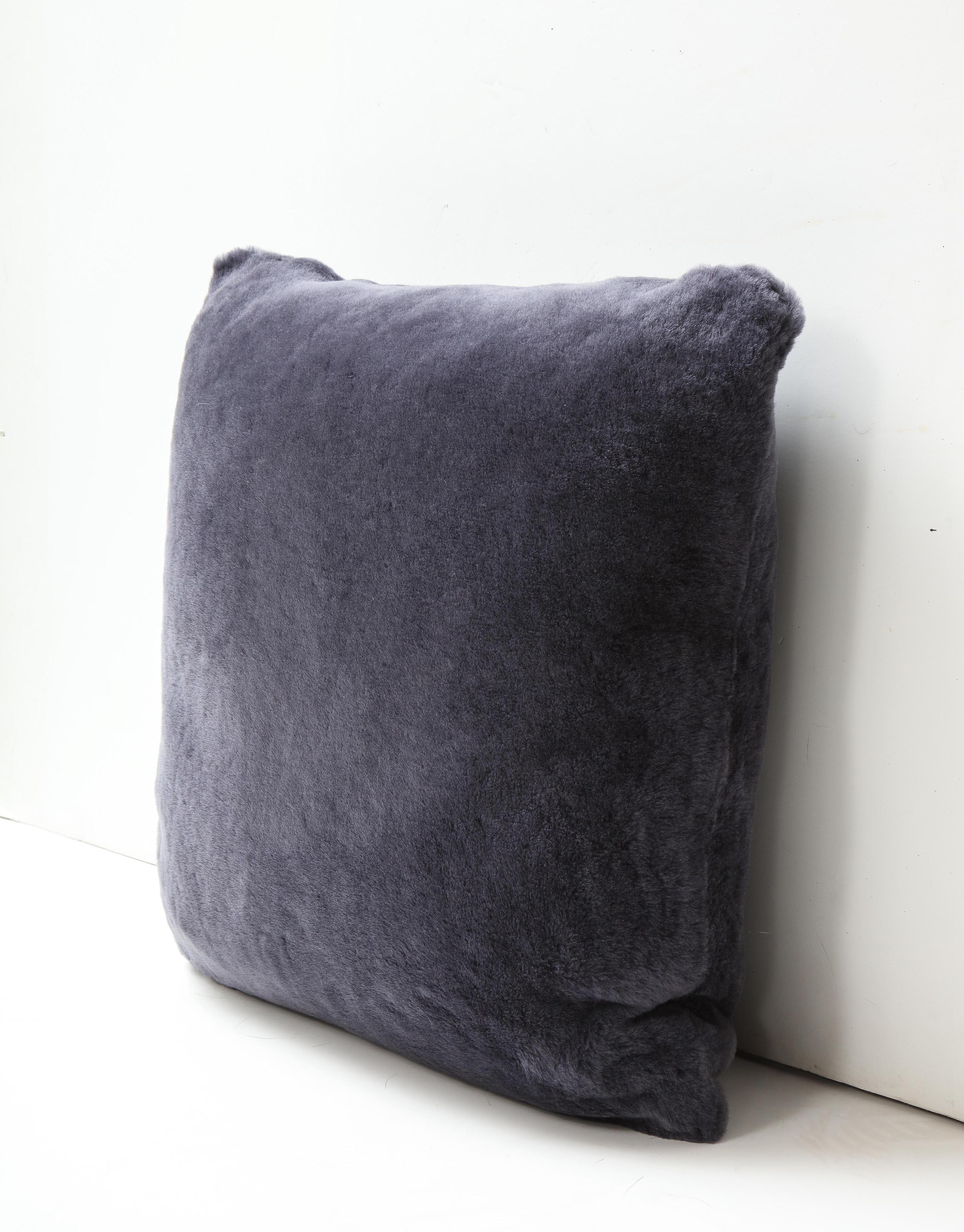 Beautiful double sided short hair Merino shearling pillow in purple grey color. Very soft and luxurious in touch with a tone of modern appeal. It is made of genuine shearing fur with a zipper enclosure in a matching color, filled with down and