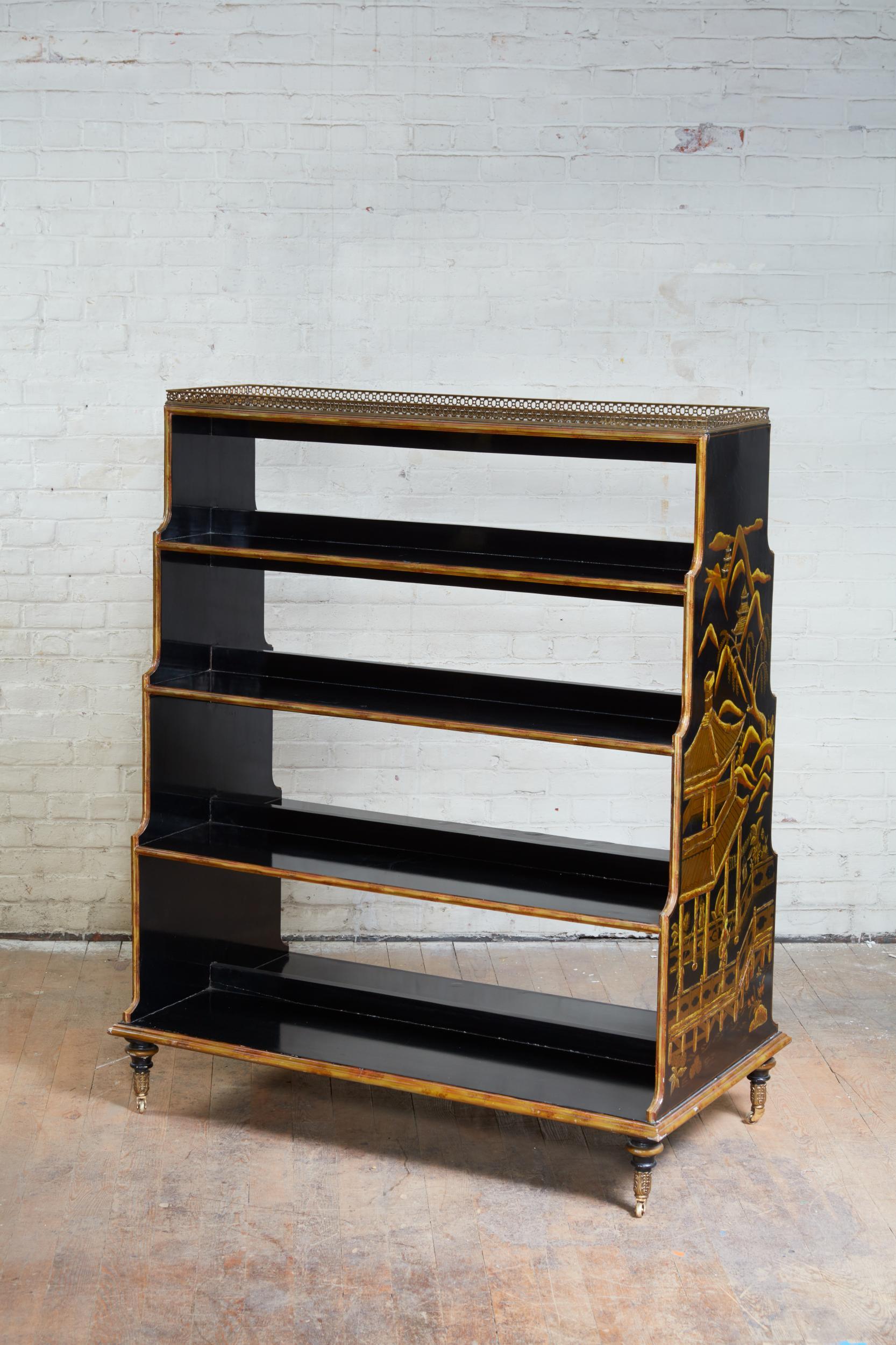 Regency style chinoiserie decorated double sided waterfall bookcase with pierced brass gallery over four graduated shelves, the two side panels lavishly decorated with fanciful scenes against a black lacquered ground, retaining original foliate cast