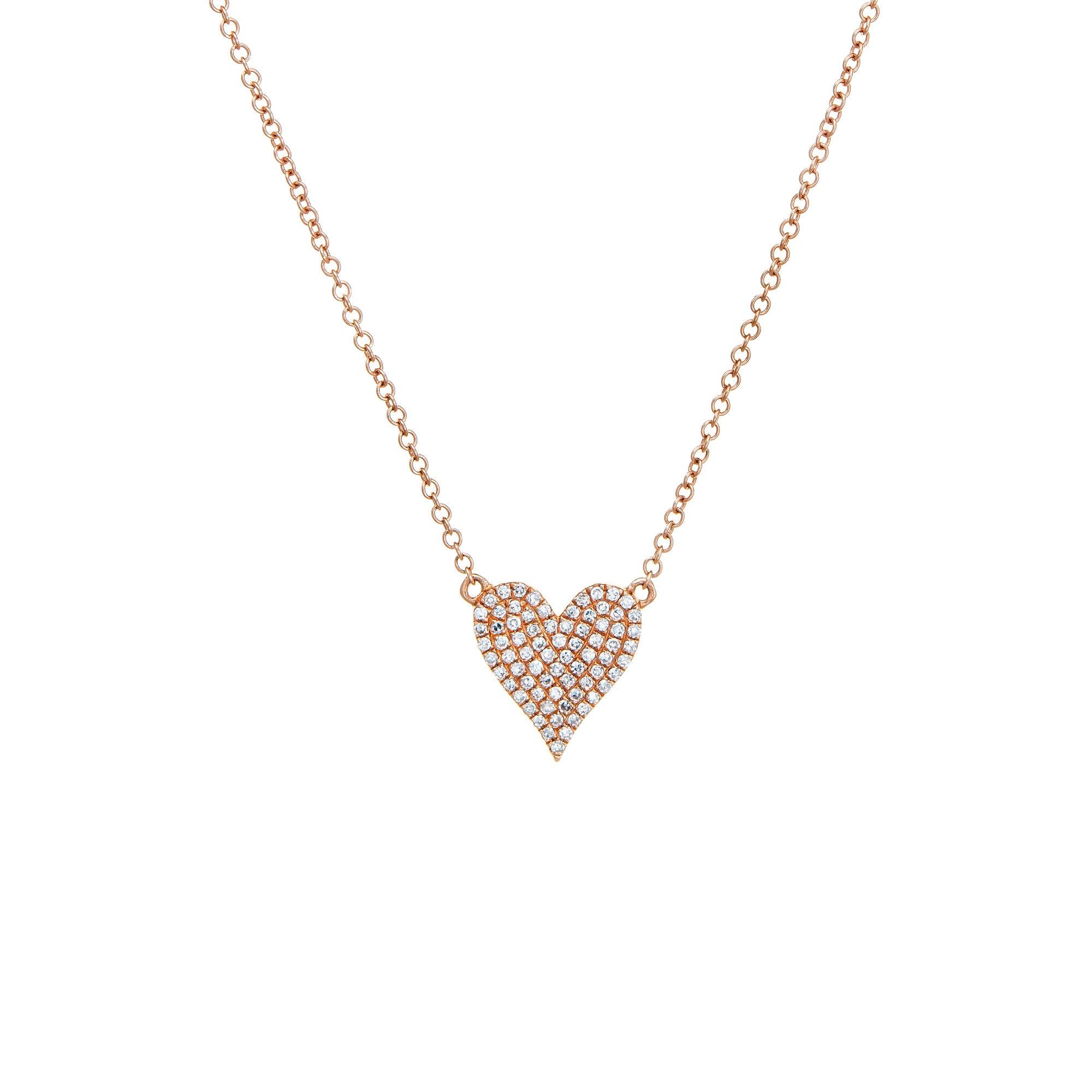Stylish and finely detailed double sided diamond & ruby heart necklace crafted in 14k rose gold.

Pave set rubies total an estimated 0.16 carats. Pave set diamonds total an estimated 0.16 carats (estimated at G-H color and VS2 clarity).

The