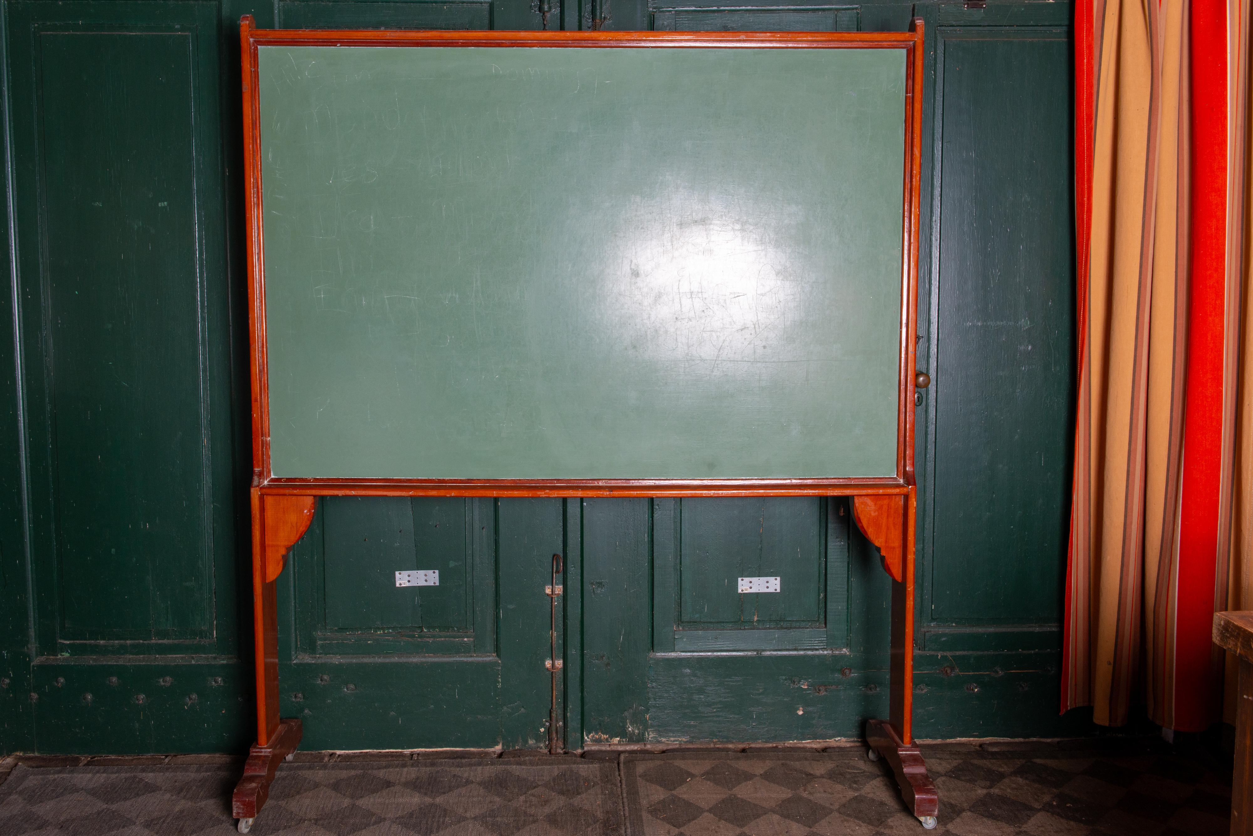 A very large 1900-1910 century chalk board from the Netherlands. The solid wood stand is substantial and easy to move on its antique casters. Great in a kid's room, a restaurant, or a store. Use your imagination.