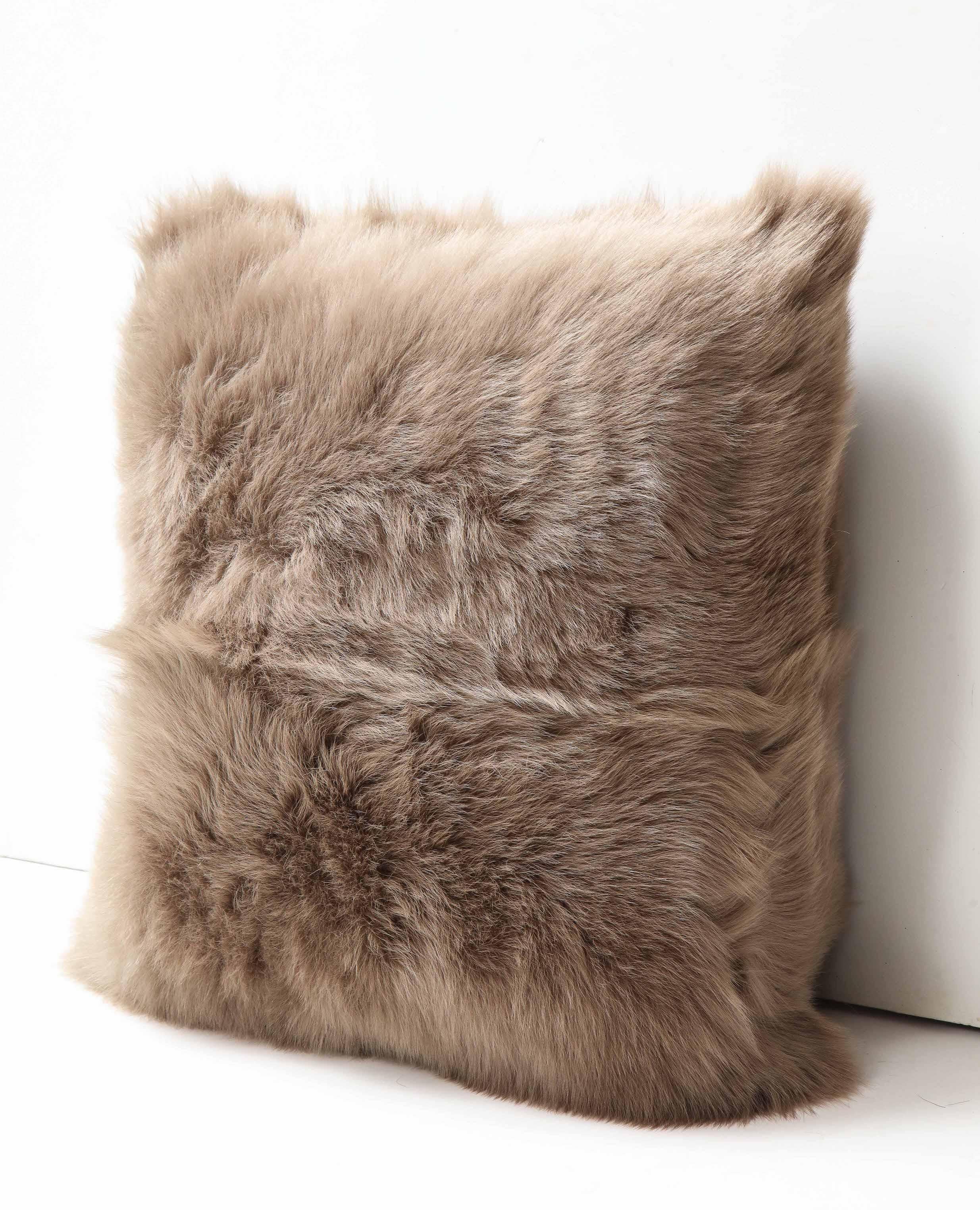 Beautiful double sided long hair Toscana shearing pillow in taupe color. Very elegant in look and tangibly luxurious and soft. It is made of genuine shearing with a zipper enclosure in a matching color, filled with down and feather, and 18