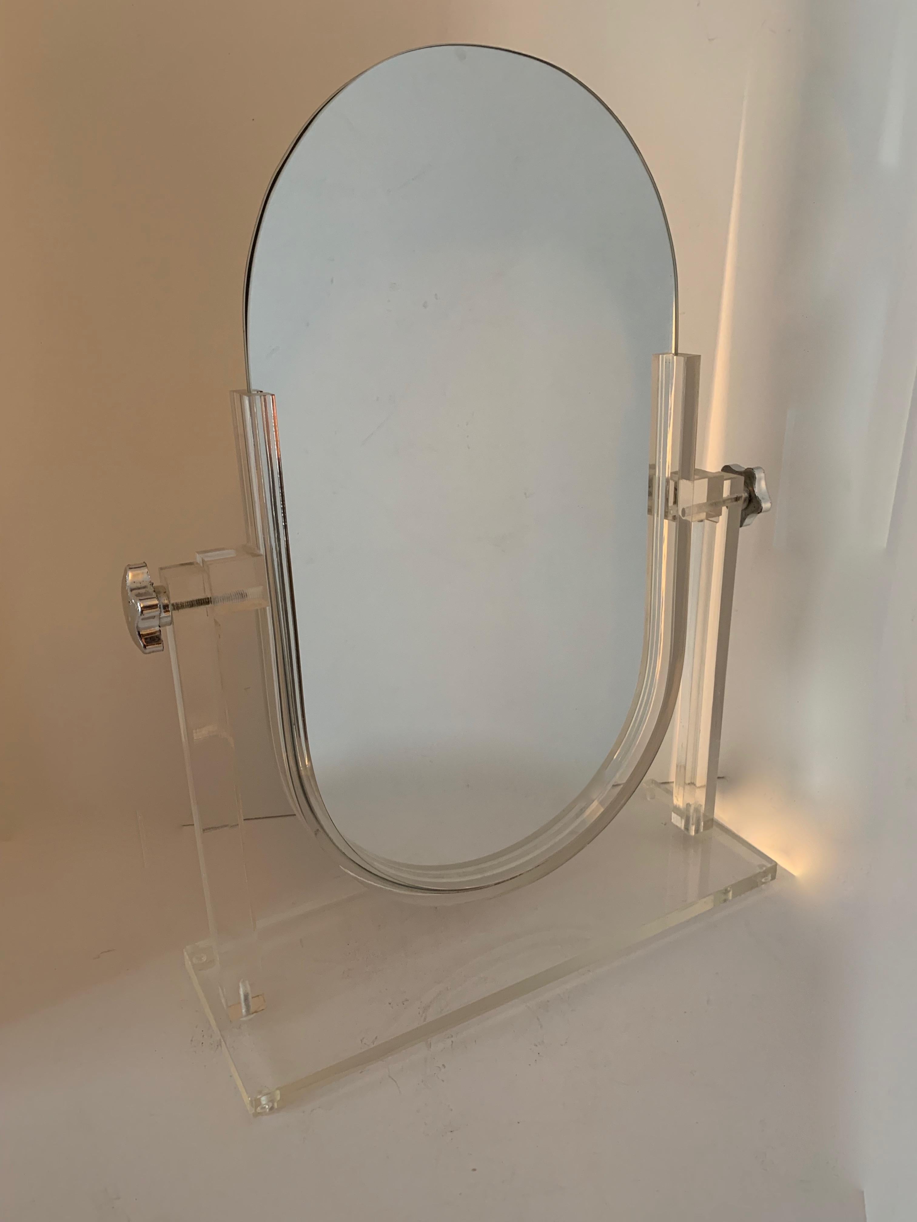 Acrylic stand holding a two mirrors - for the vanity or dressing table... both mirrors are normal and do not magnify. Can be adjusted to tilt in many directions. The mirrors are easily removed for cleaning or replacement, just slide out (see photo).
