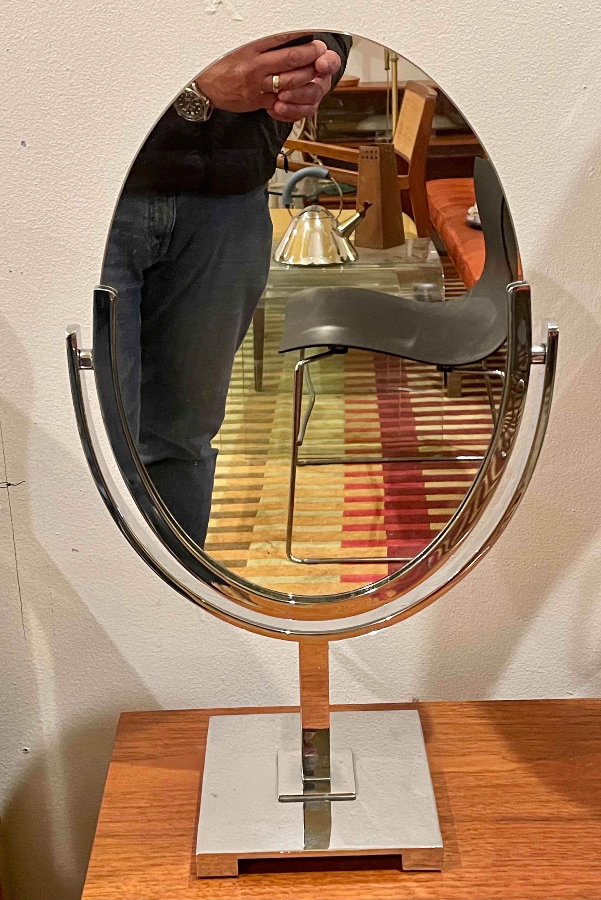 Solid steel chrome-plated oval mirror, swivels circa 1970s in excellent condition we have polished the chrome looks great the mirror has no chips or cracks.