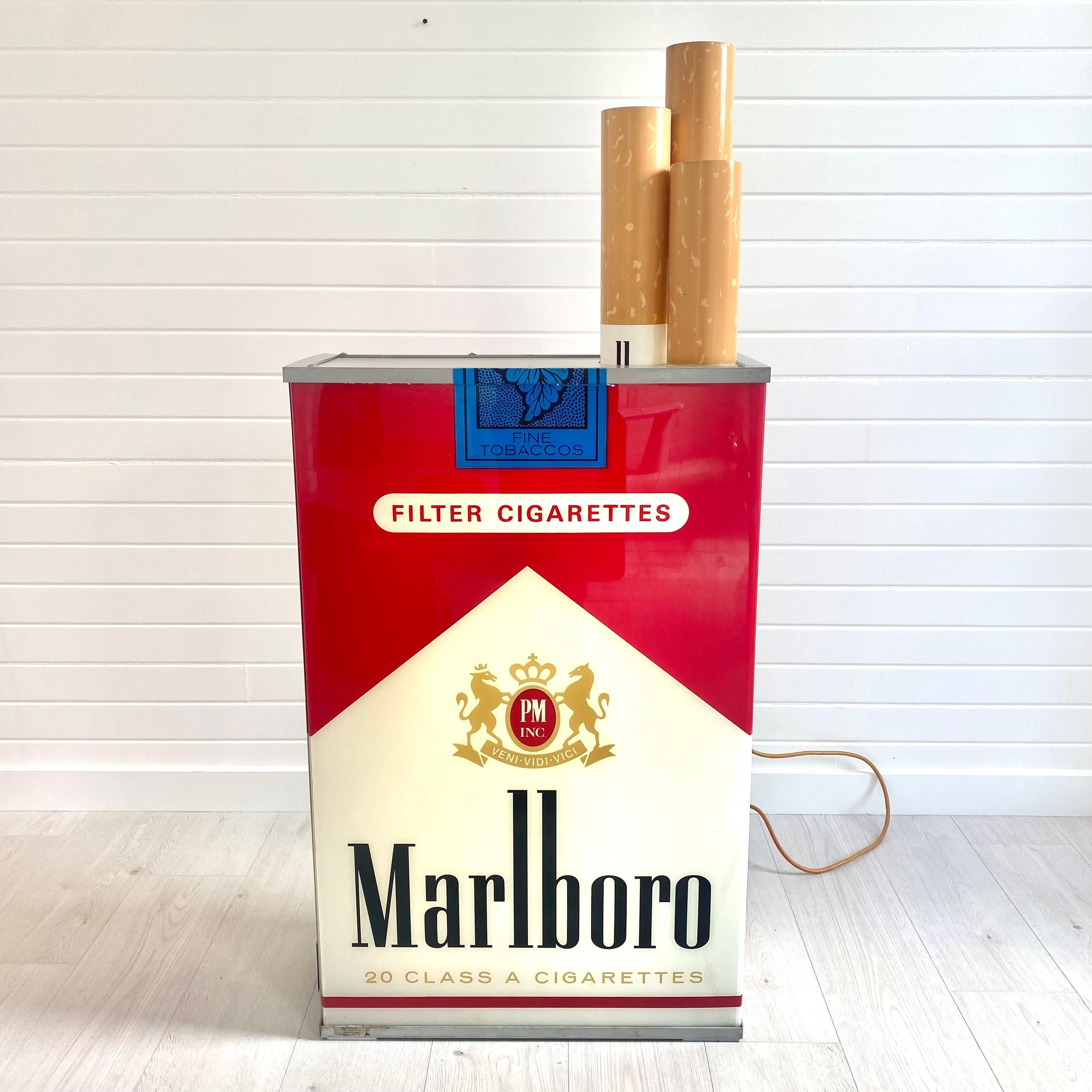 Fantastic vintage advertising light up box by Marlboro. A relic of 90's commercial culture. Massive scale. Double sided. Good condition with wear as shown. Looks great hanging on the wall or on the ground. Acrylic sides and cigarettes with metal