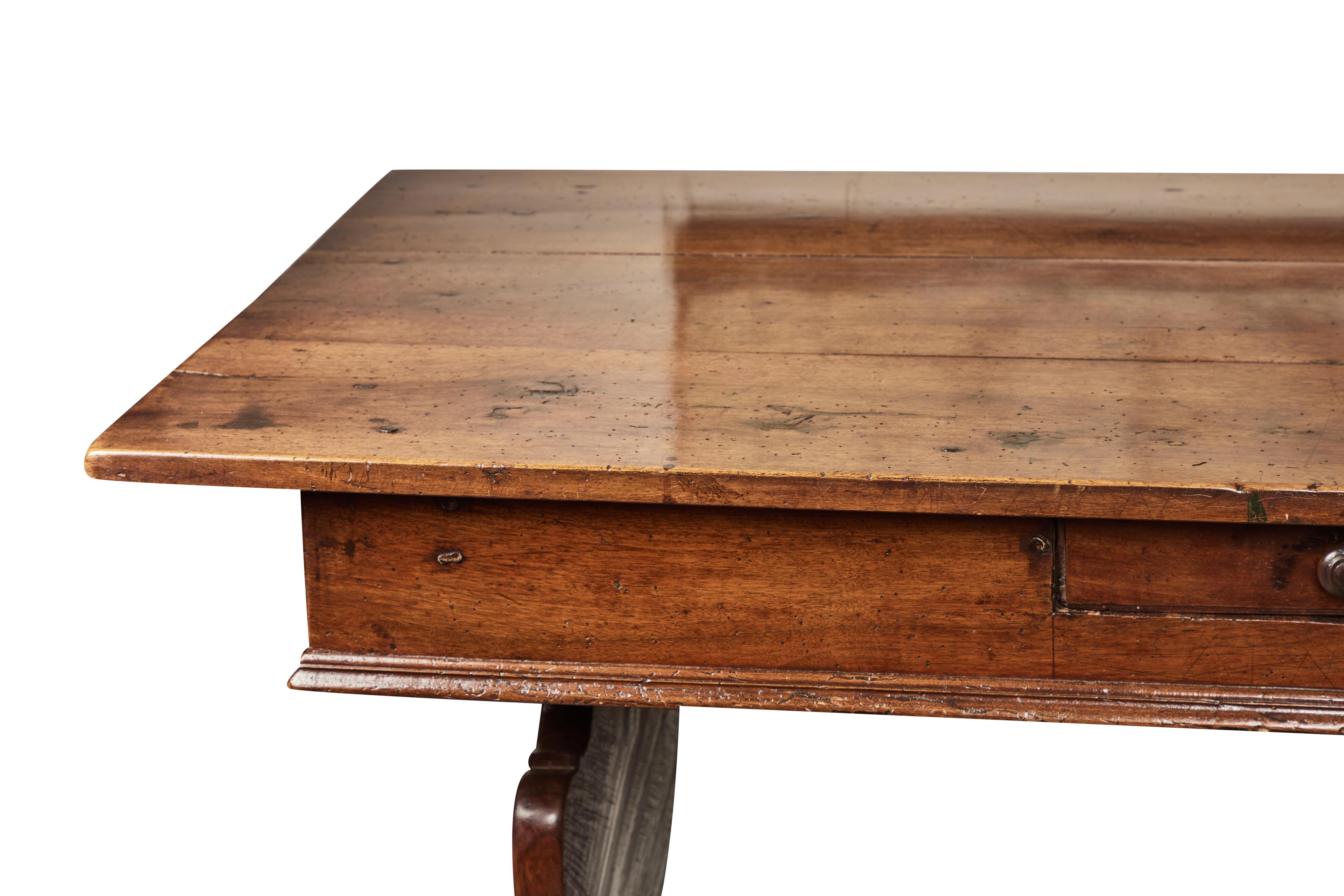 Double sided, 3 plank top, walnut library table with 2 drawers on each side. Urn shaped legs connect the stretcher. Beautiful patina on wood.