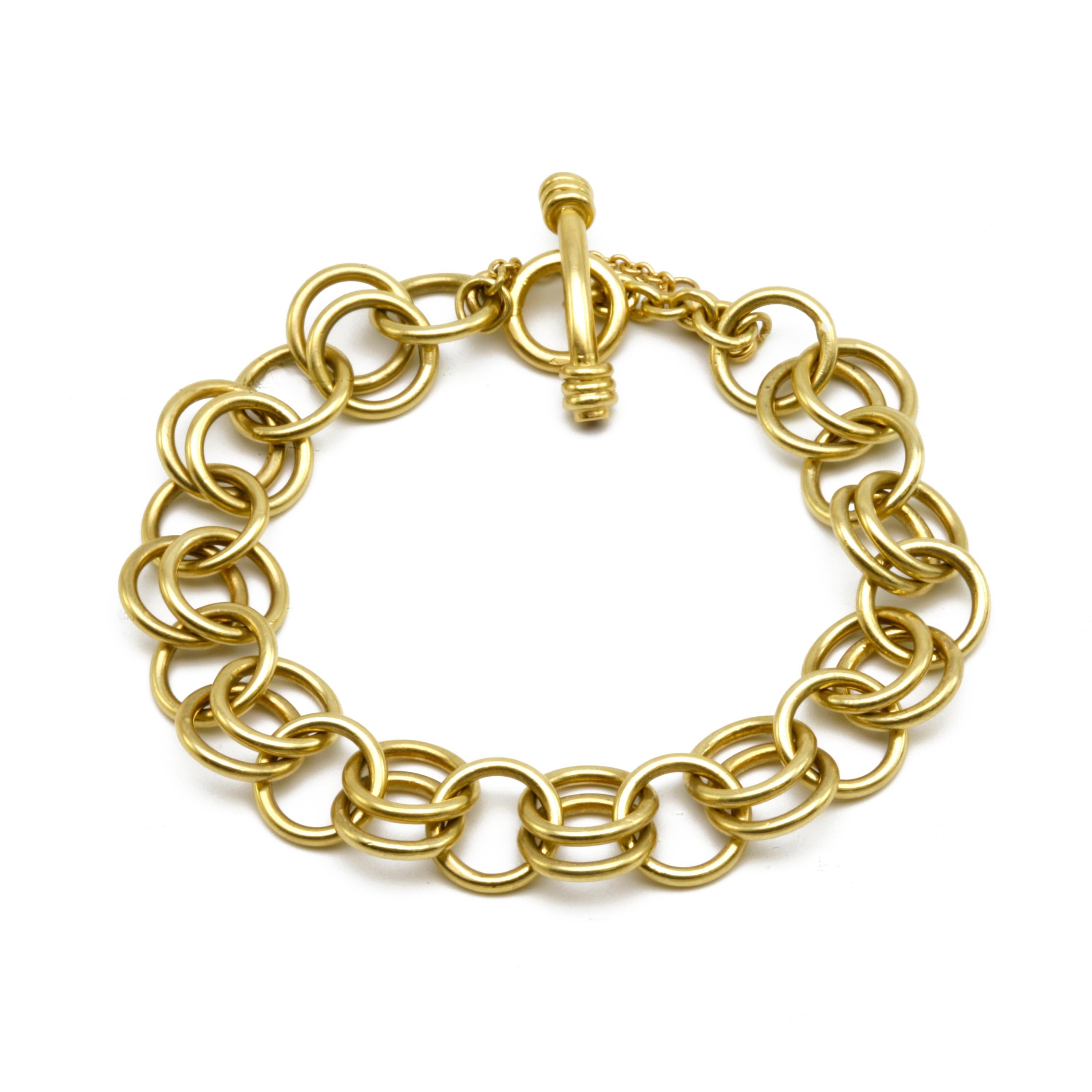 Hours of repetitive forming by hand go into this masterful chain. The double links traditionally allow for charms to double-up on each linked section should the wearer choose. Solid 18k gold. The toggle clasp has Ruby ends. Different link