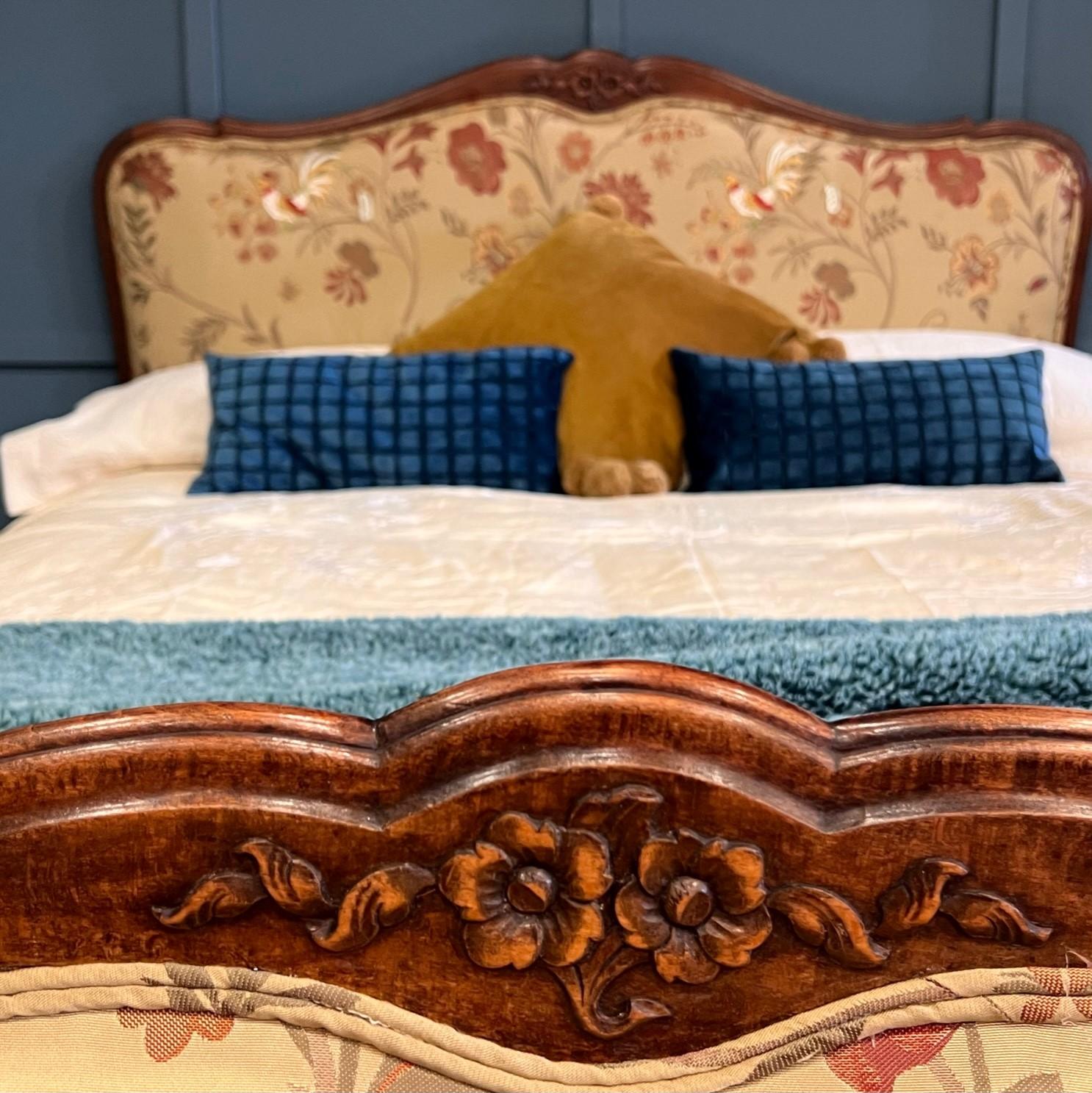 Double, 4’6 wide antique French upholstered bed with an oak frame. The bed has been newly upholstered in a GP & J Baker embroidered fabric in a stunning gold colour.

The fabric has pretty birds on it and the frame has been cleaned and polished to