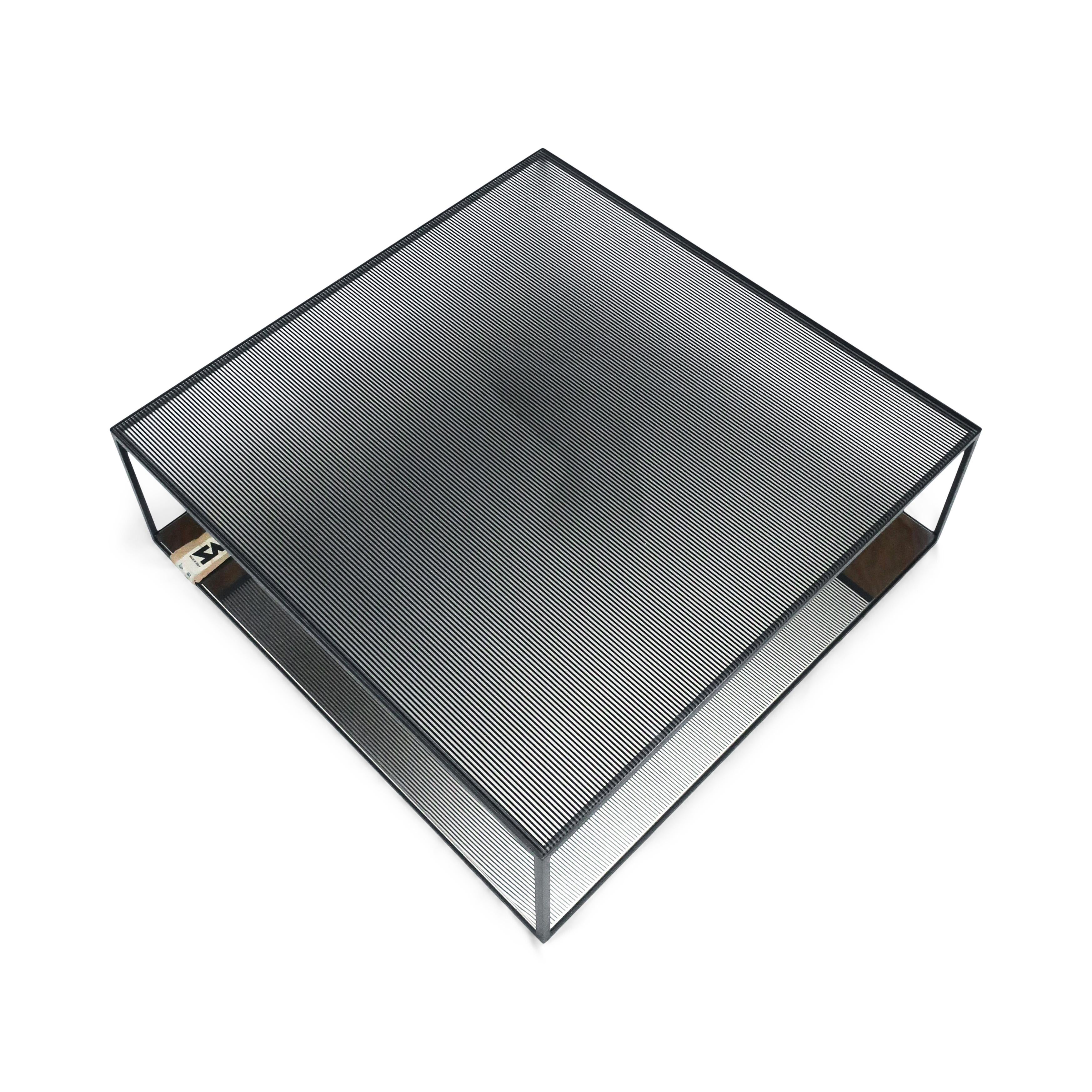 A stunning coffee or cocktail table designed by Maurizio Peregalli for Zeus. It has a reverse screen-printed glass top and polished stainless steel on bottom, all sitting on a dark gray metal frame. The eight mm tempered glass top has
