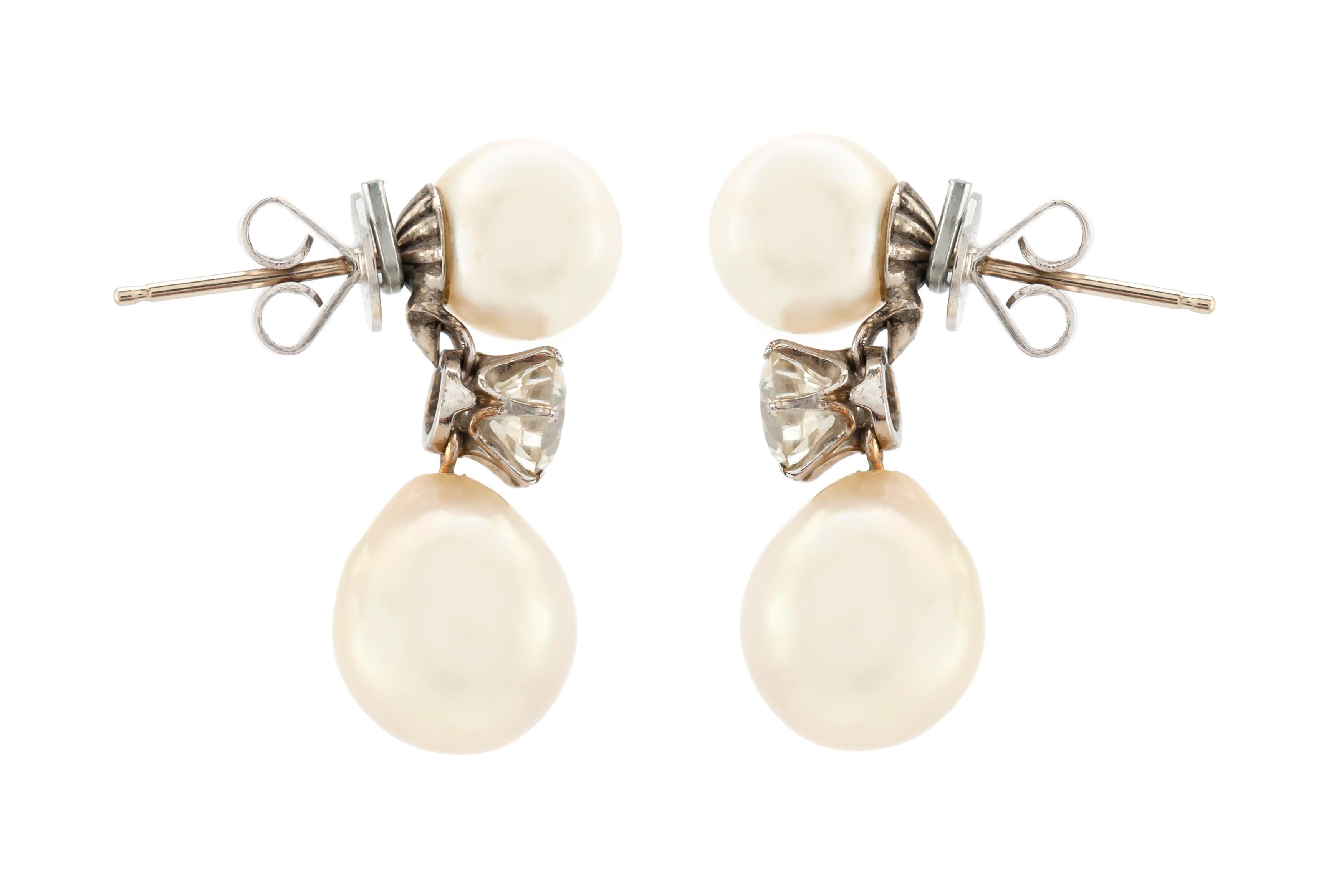 The earrings are finely crafted in 14k white gold with four beautiful pearls and diamonds weighing approximately total of 1.30 carat.