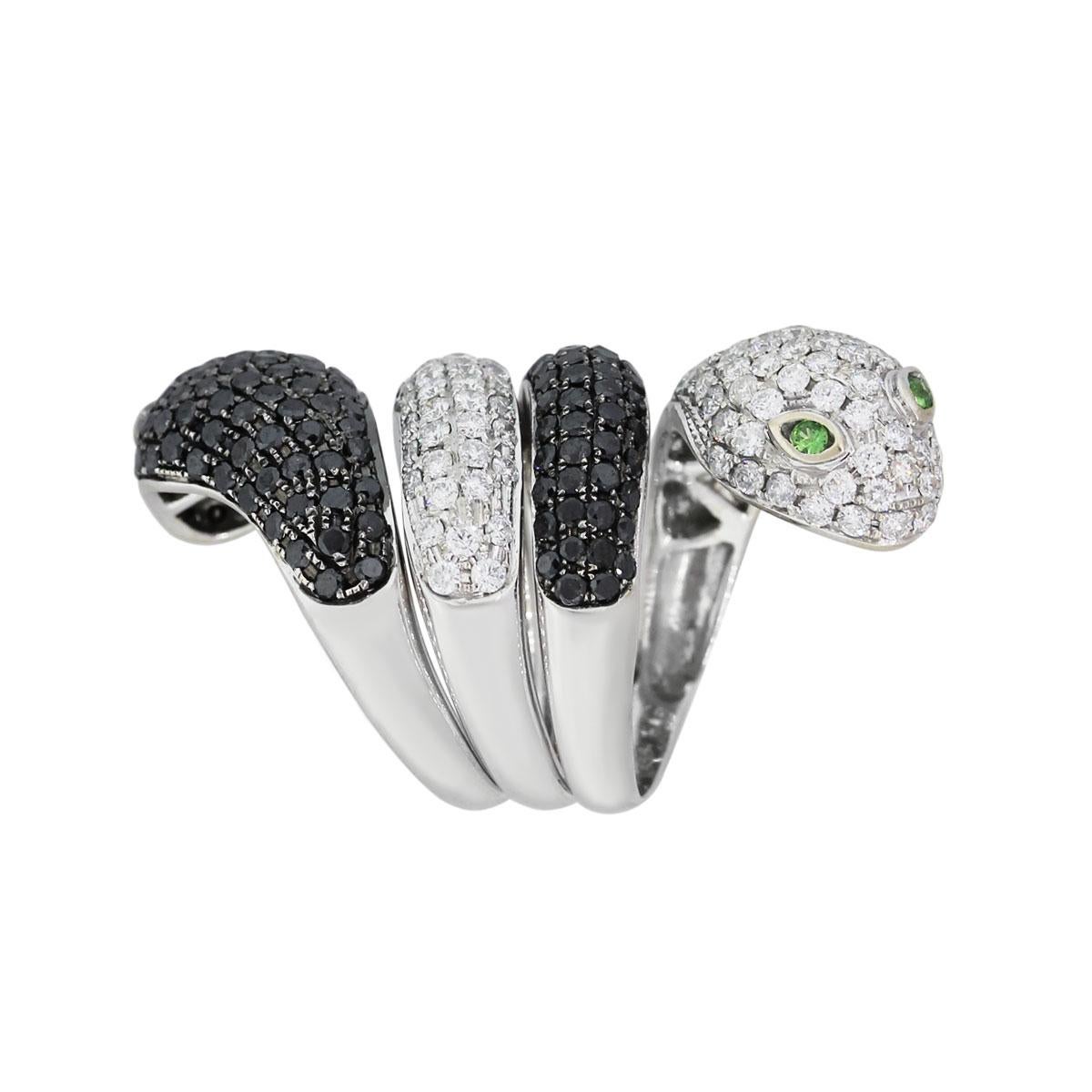 Material: 18k white gold
Diamond Details: Approximately 3.33 ctw of round brilliant white and black diamonds. White diamonds are G/H in color and VS in clarity.
Gemstone Details: Approximately 0.10ctw of round shape emeralds
Ring Size: 7.75
Ring
