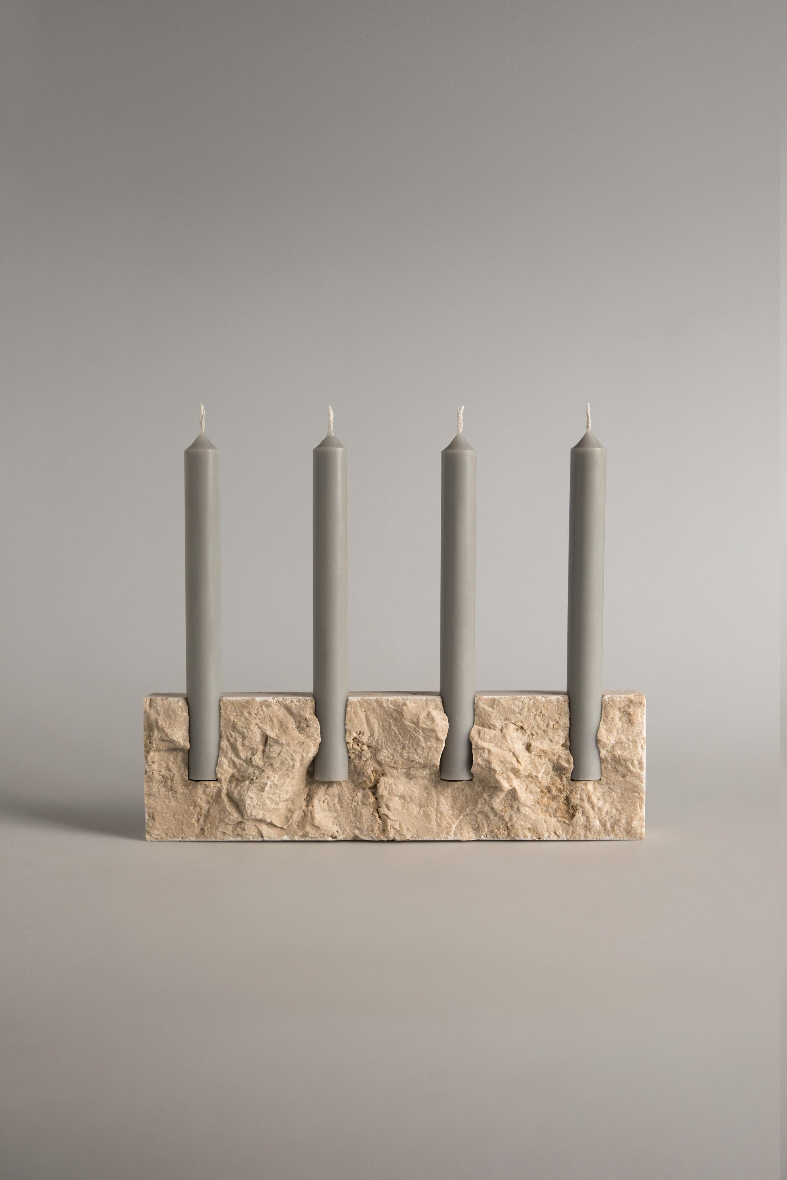 Handcrafted candle holder in bone-white travertine with rock face front (hand chipped) and smooth sides. Please note that each stone is unique and reacts differently, therefore important variations in colour, shape and texture occur. 

Snug candle